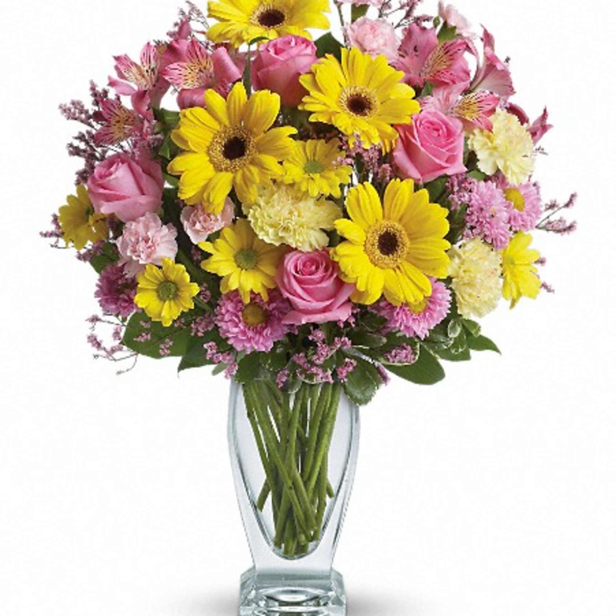 Pink roses and yellow daisies in a clear glass vase