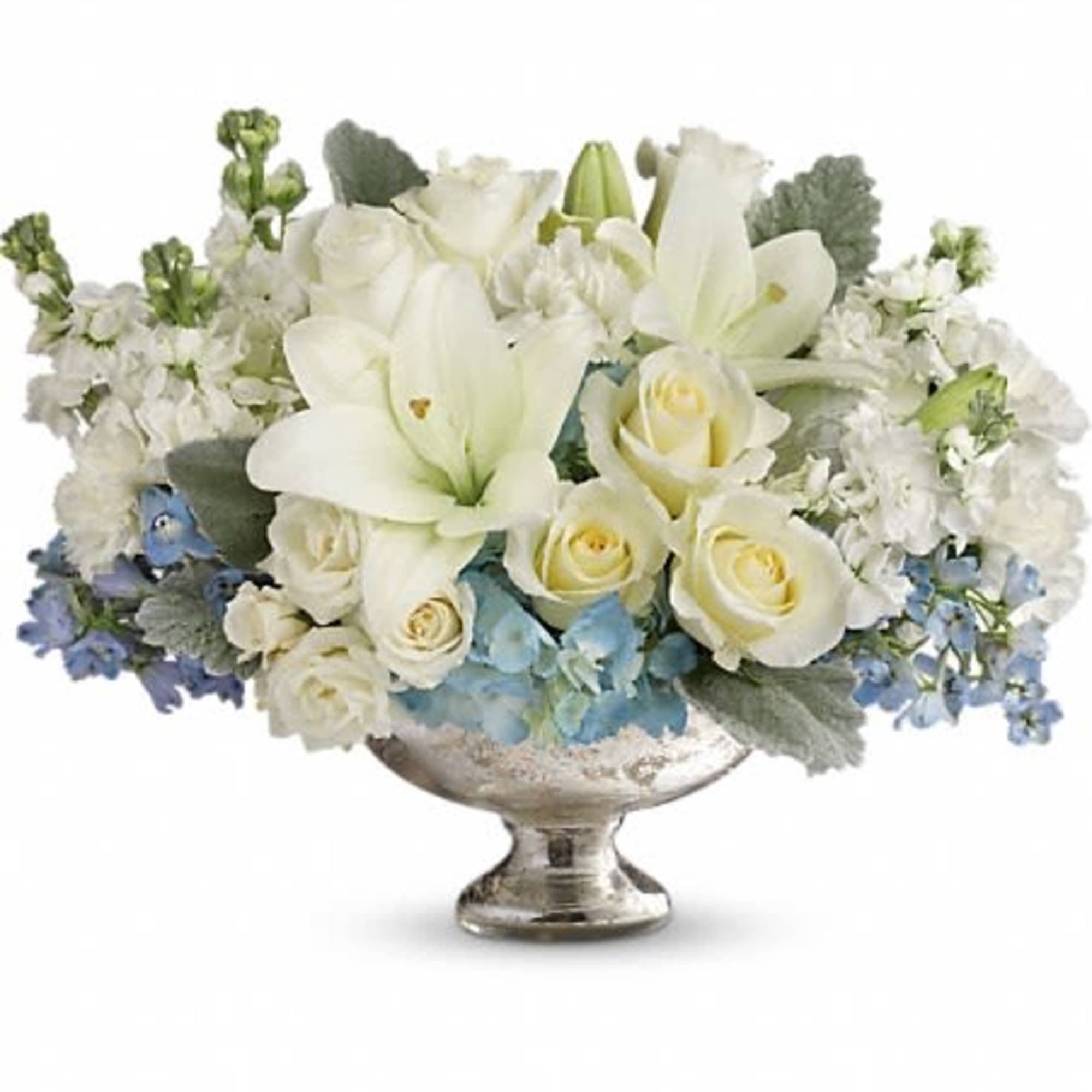 White lilies and roses arranged in a silver pedestal bowl