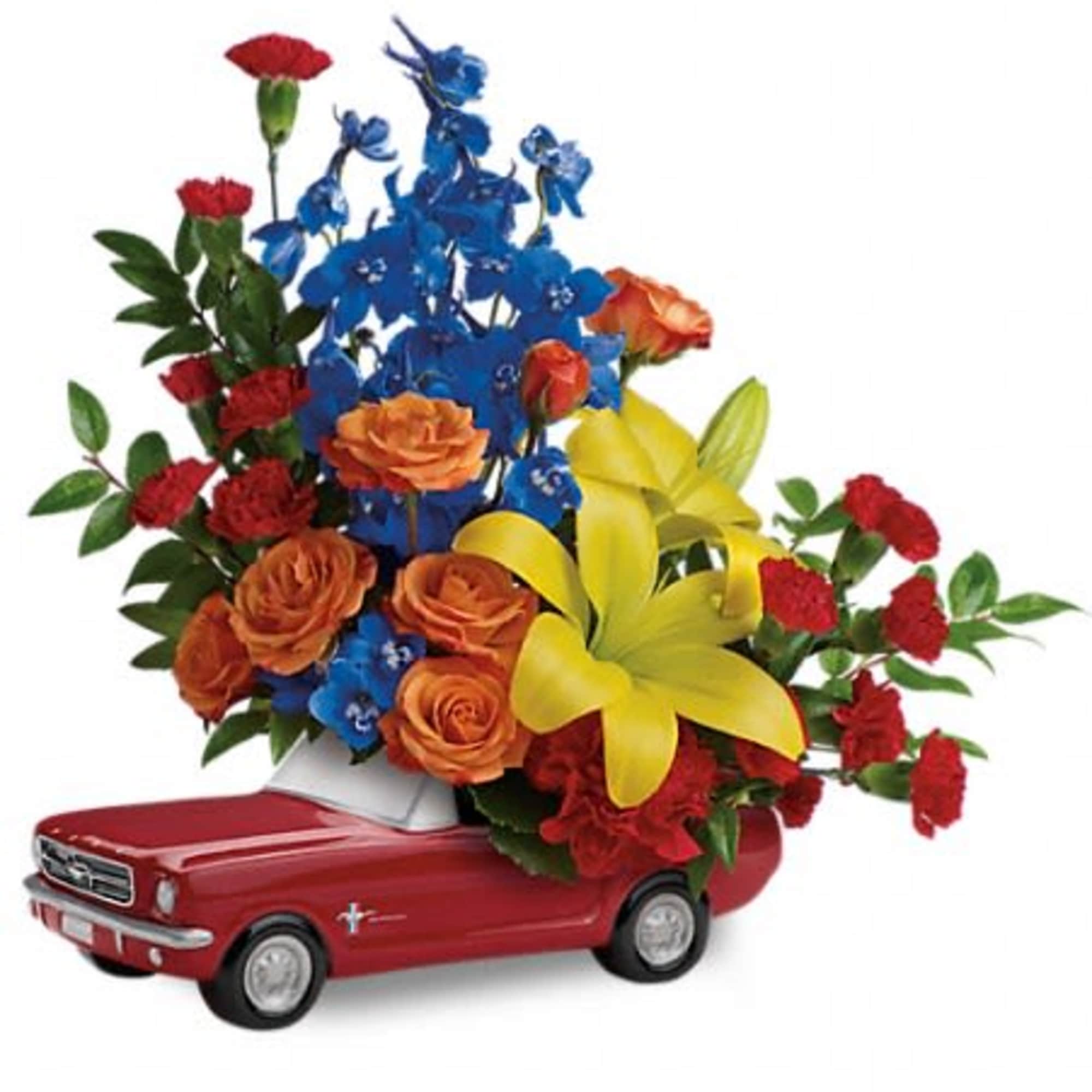 Flower arrangement in a red toy pickup truck with roses and lilies