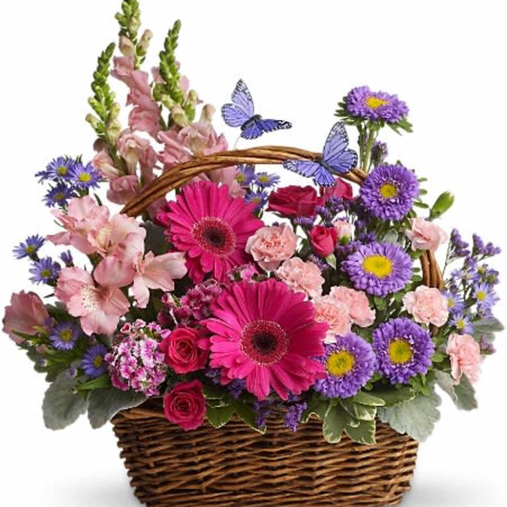 Mixed pink and purple flowers arranged in a wicker basket with butterfly picks