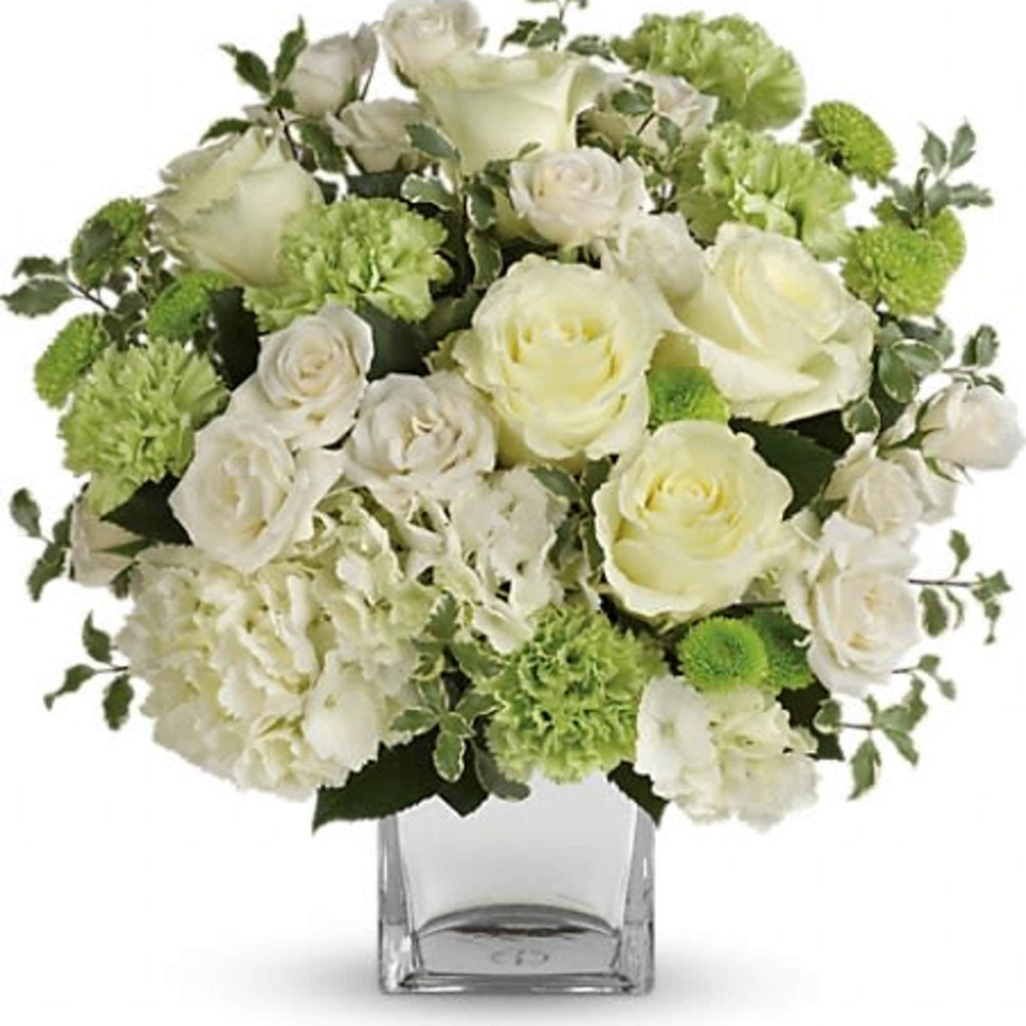White roses and green carnations in a clear glass vase
