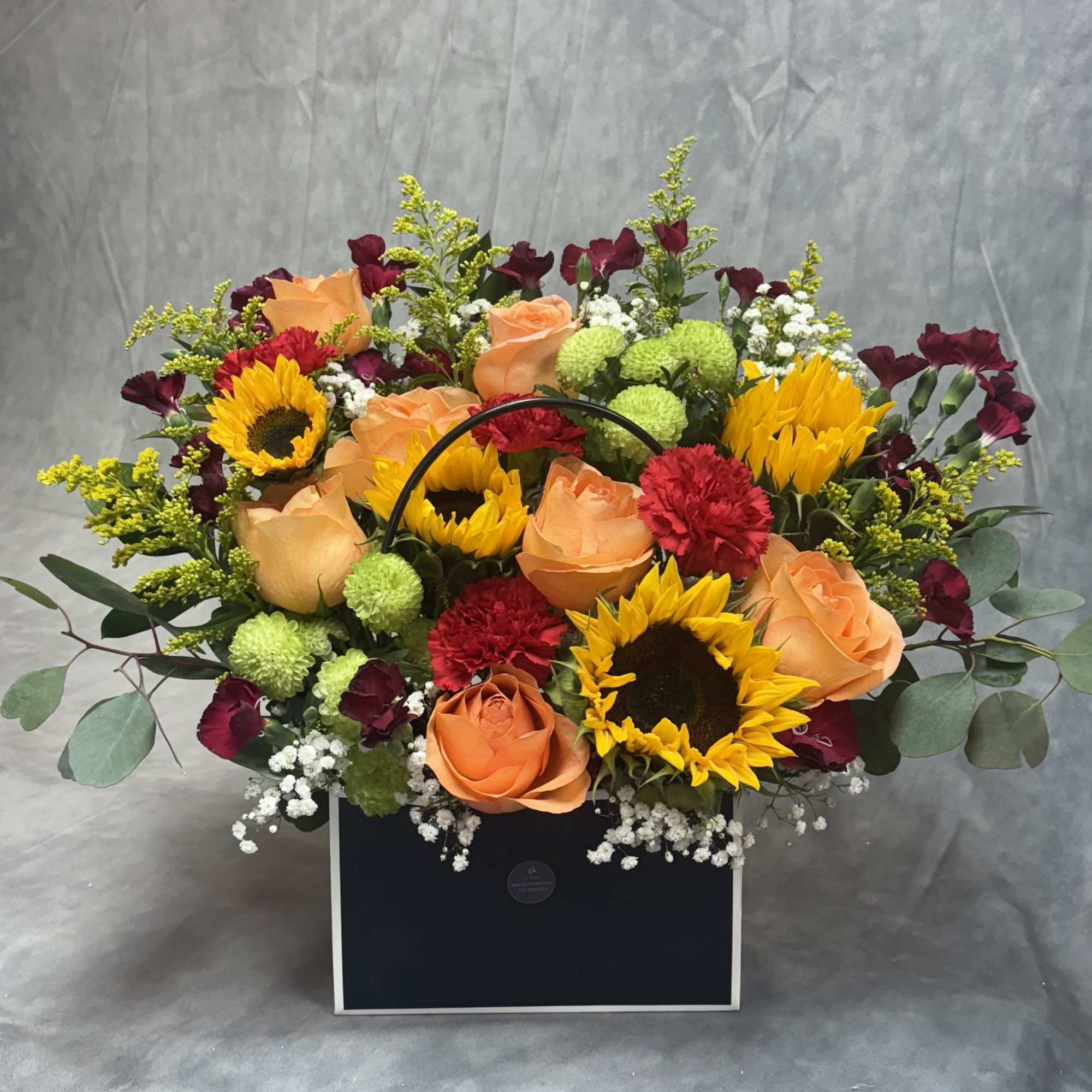 Introducing our design Surprise Me! Beautifully arranged with sunflowers, roses , delphiniums