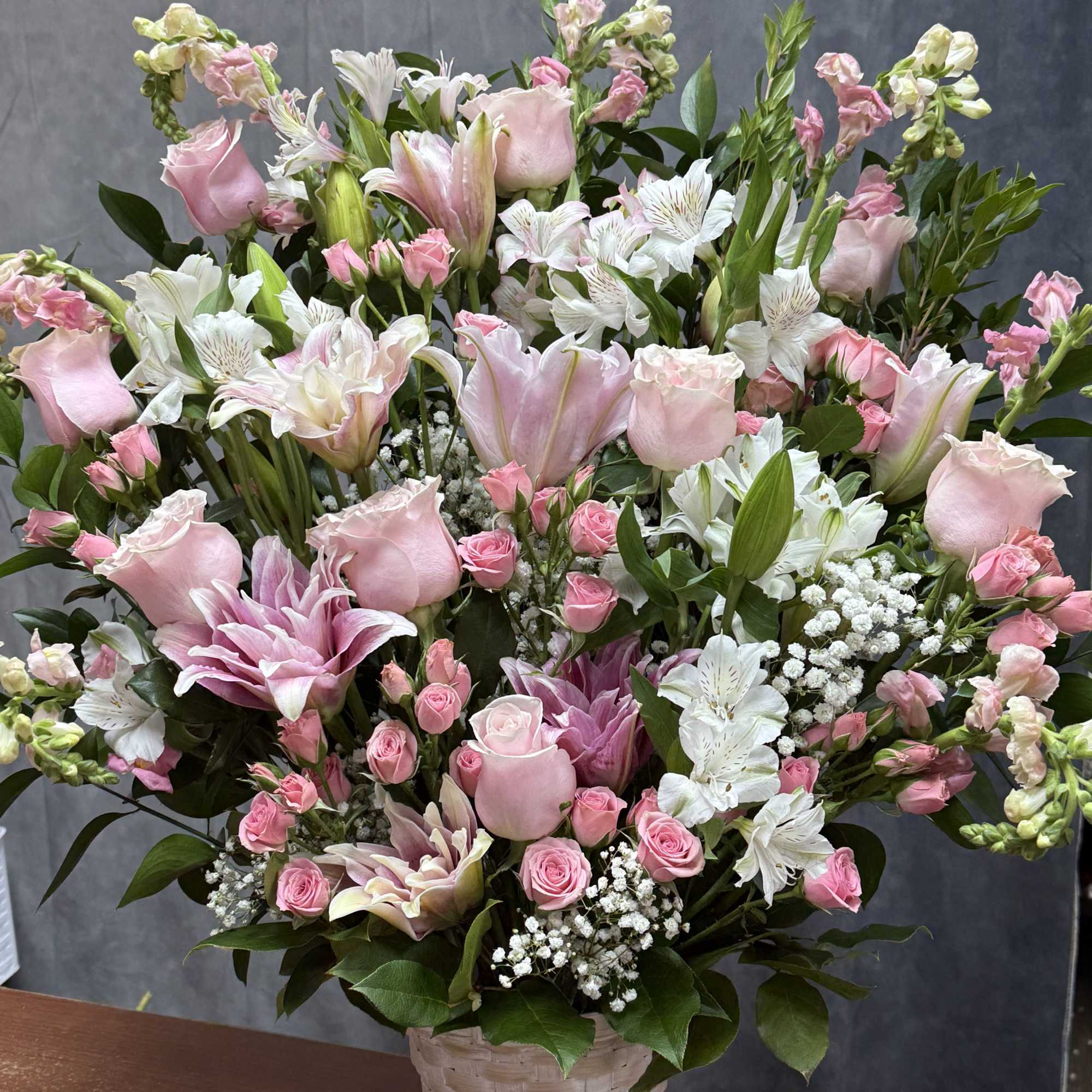 A soft and soothing mix of white lilies, pink roses, spray roses