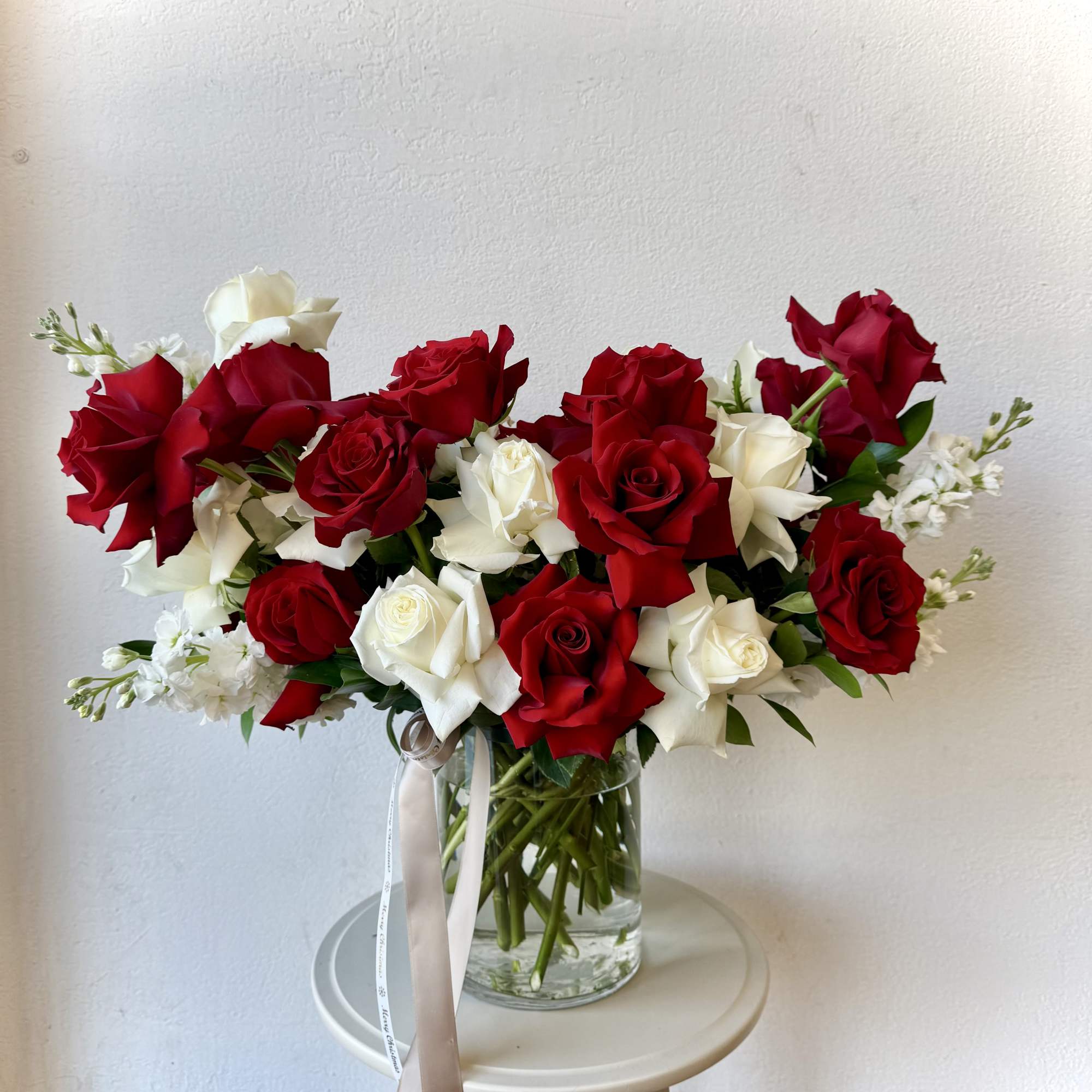 Bouquet of red and white roses in a clear glass vase