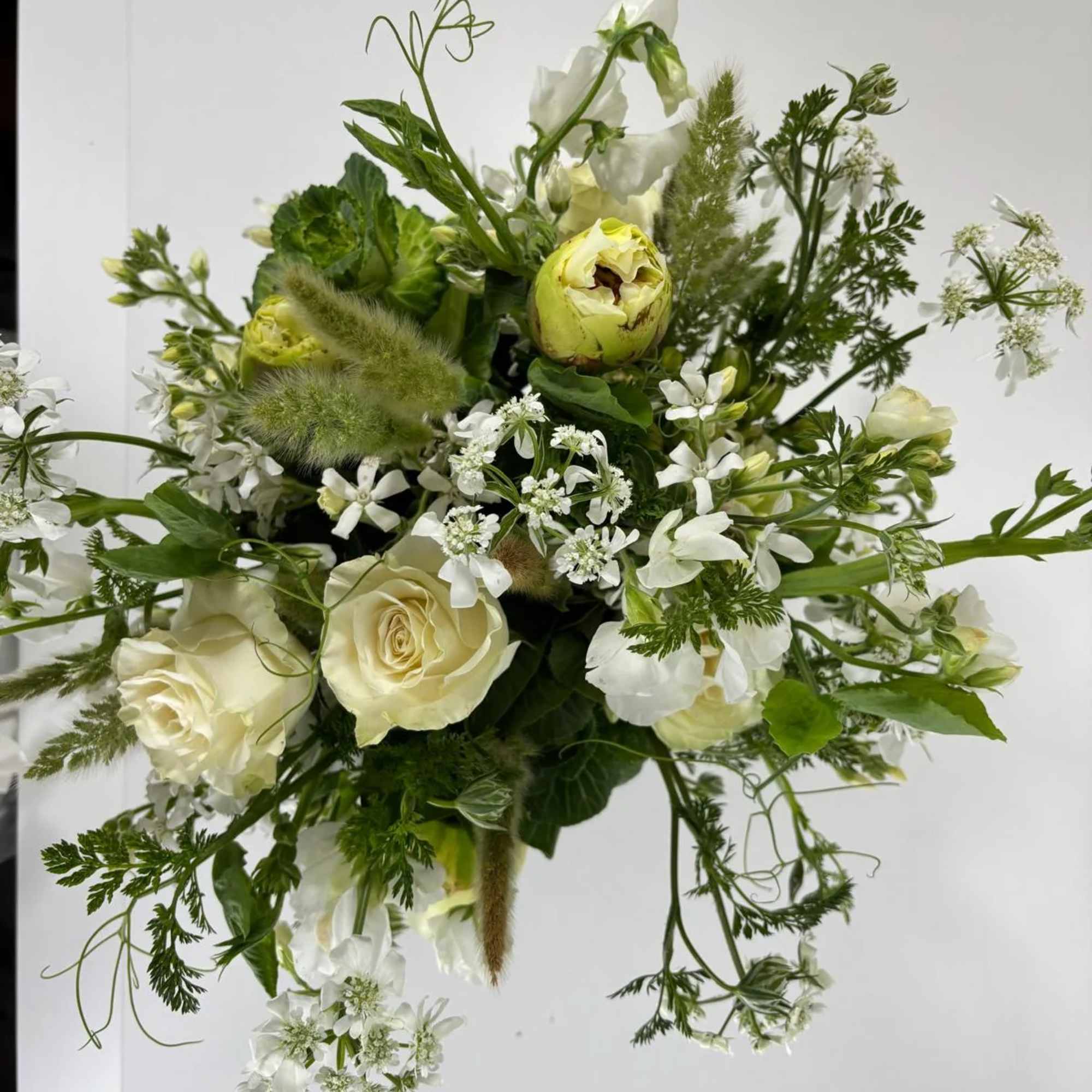 Loose white and pale green bouquet with roses and airy filler flowers