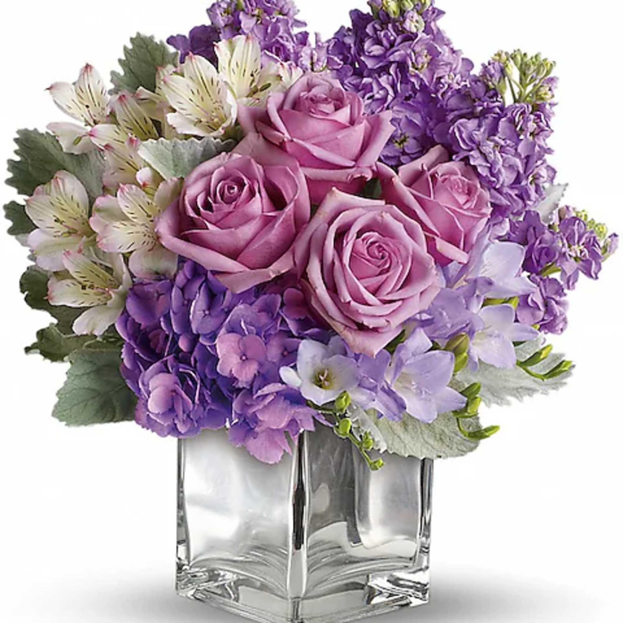 Pink and purple flower arrangement in a clear glass vase