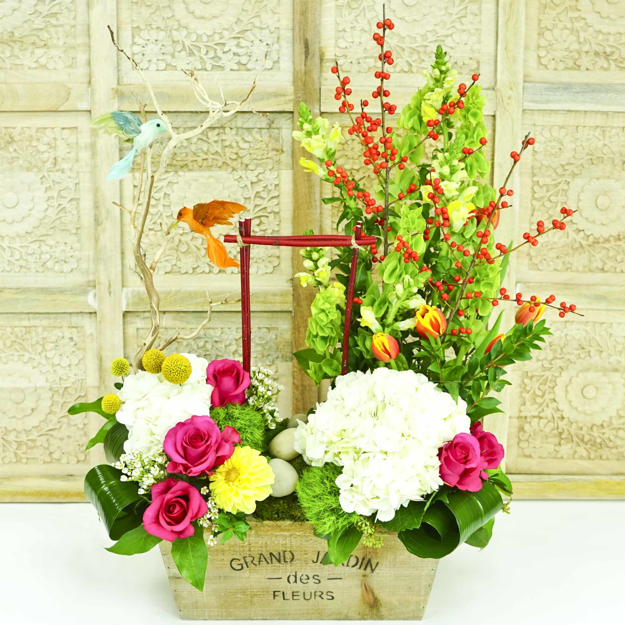 Mixed floral arrangement in a wooden box with decorative birds