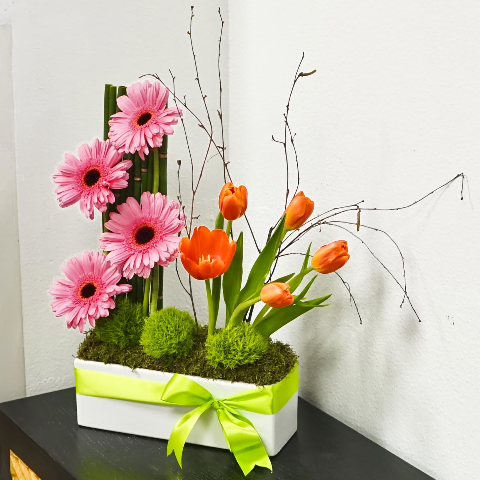 Pink gerbera daisies and orange tulips in a white box with a lime ribbon, photo 4 of 4