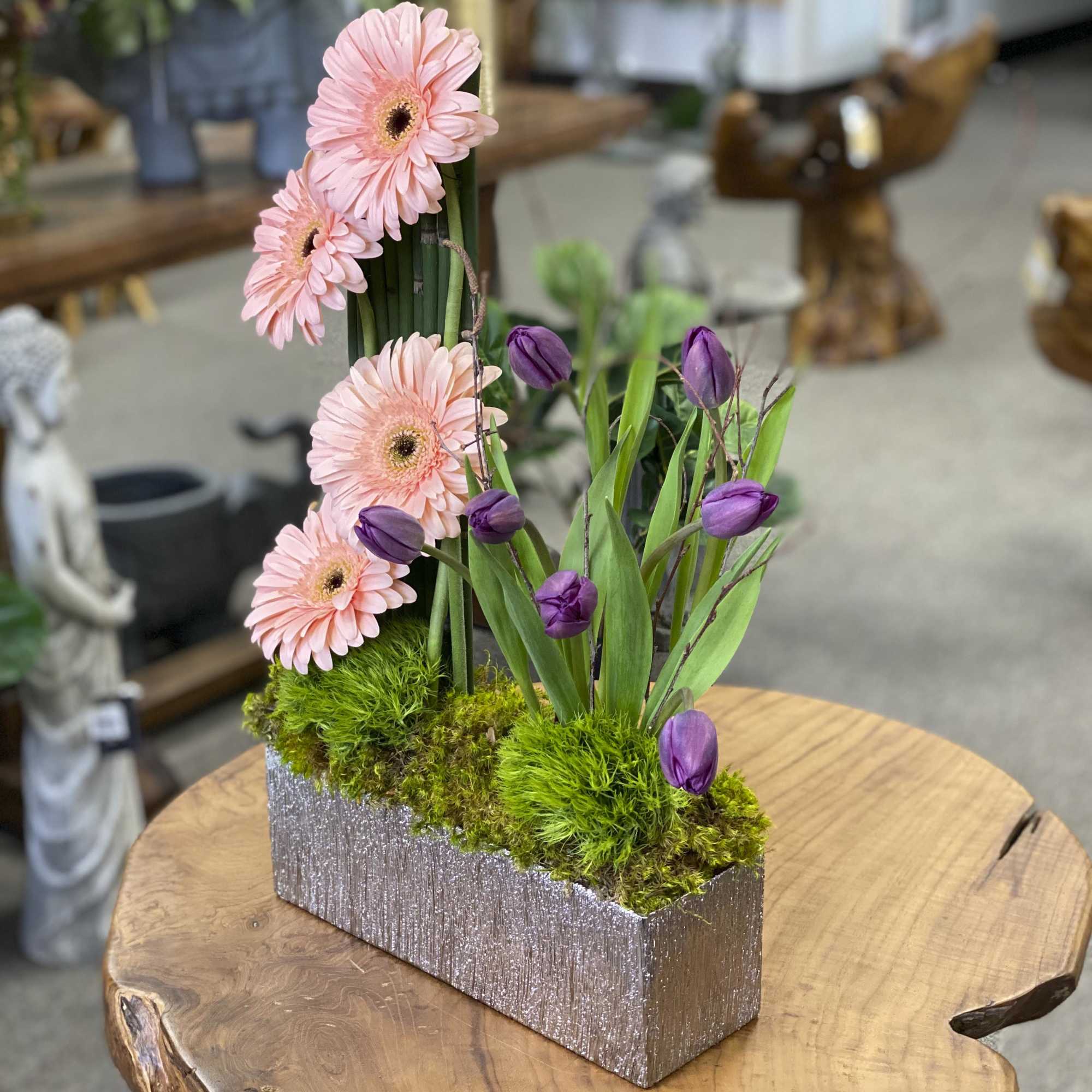 Pink gerbera daisies and purple tulips in a glittery rectangular container, photo 3 of 3
