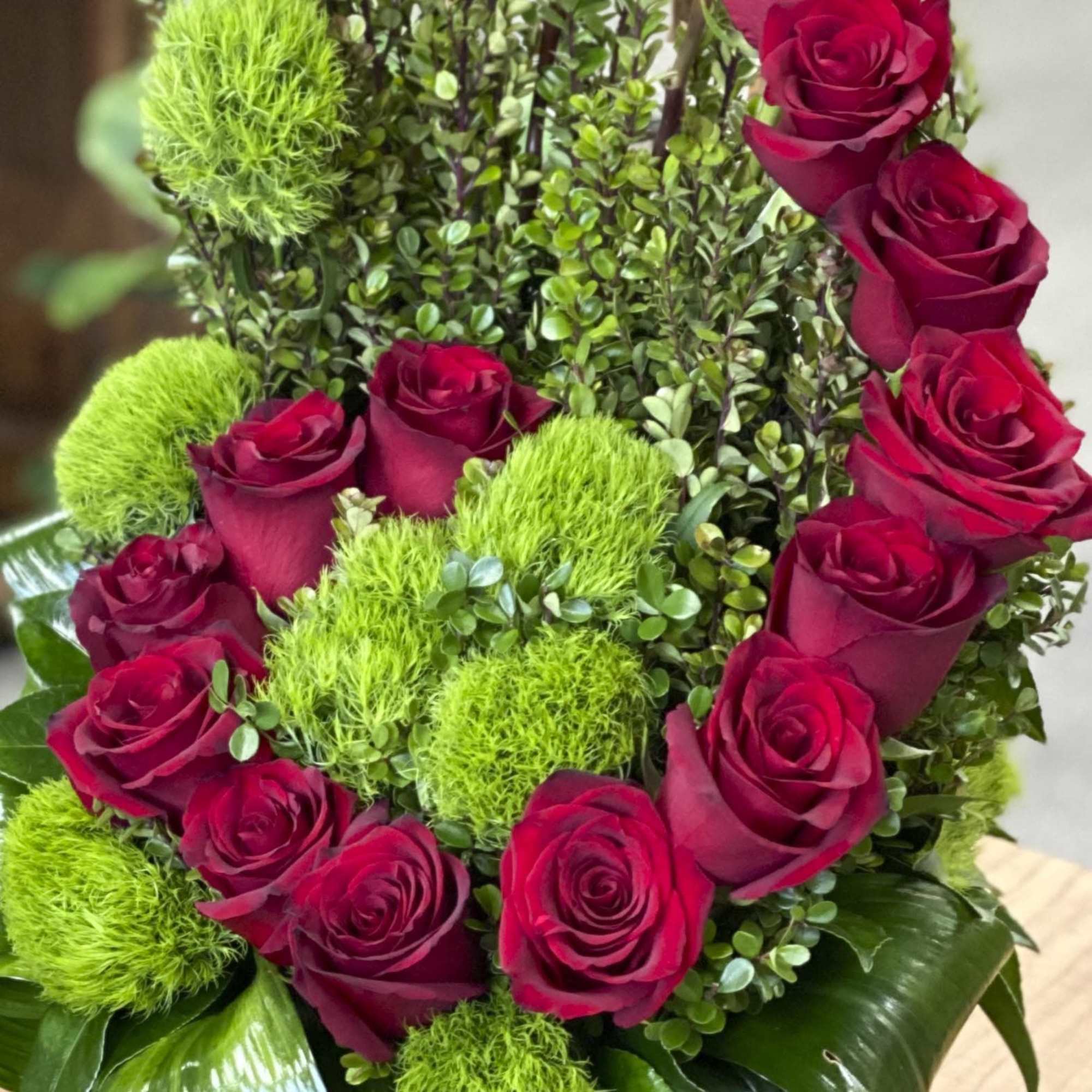 Bouquet of red roses with bright green pom-pom flowers