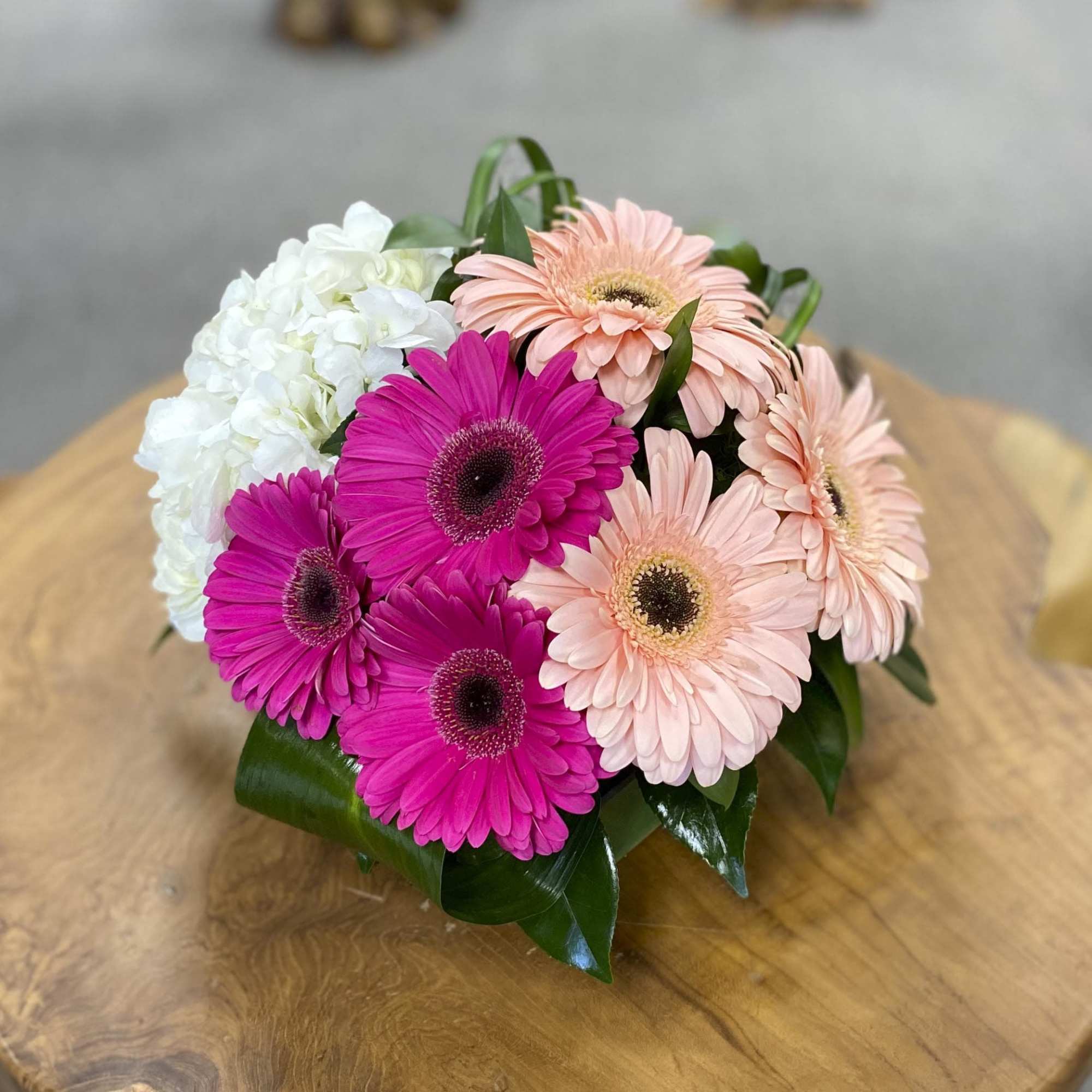 Bouquet of pink and peach gerbera daisies with white hydrangea