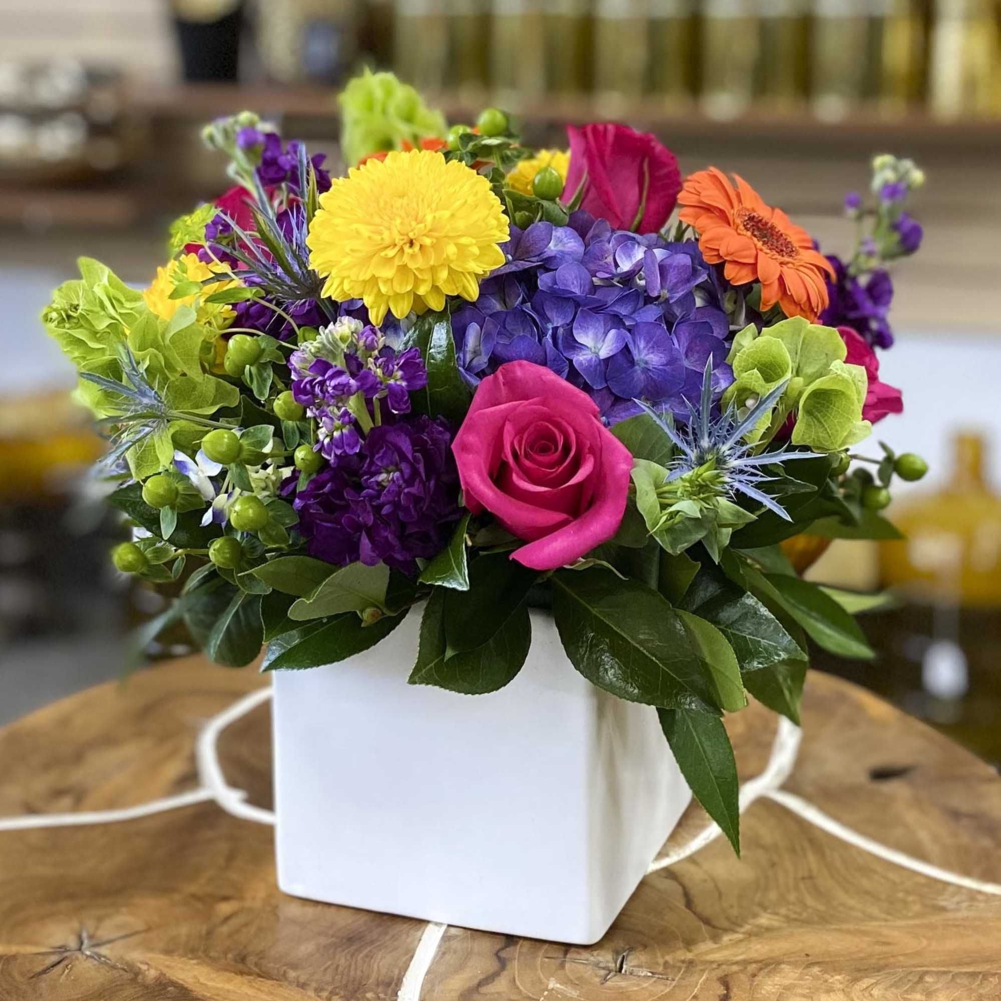 Colorful mixed flower arrangement in a white square vase, photo 3 of 3