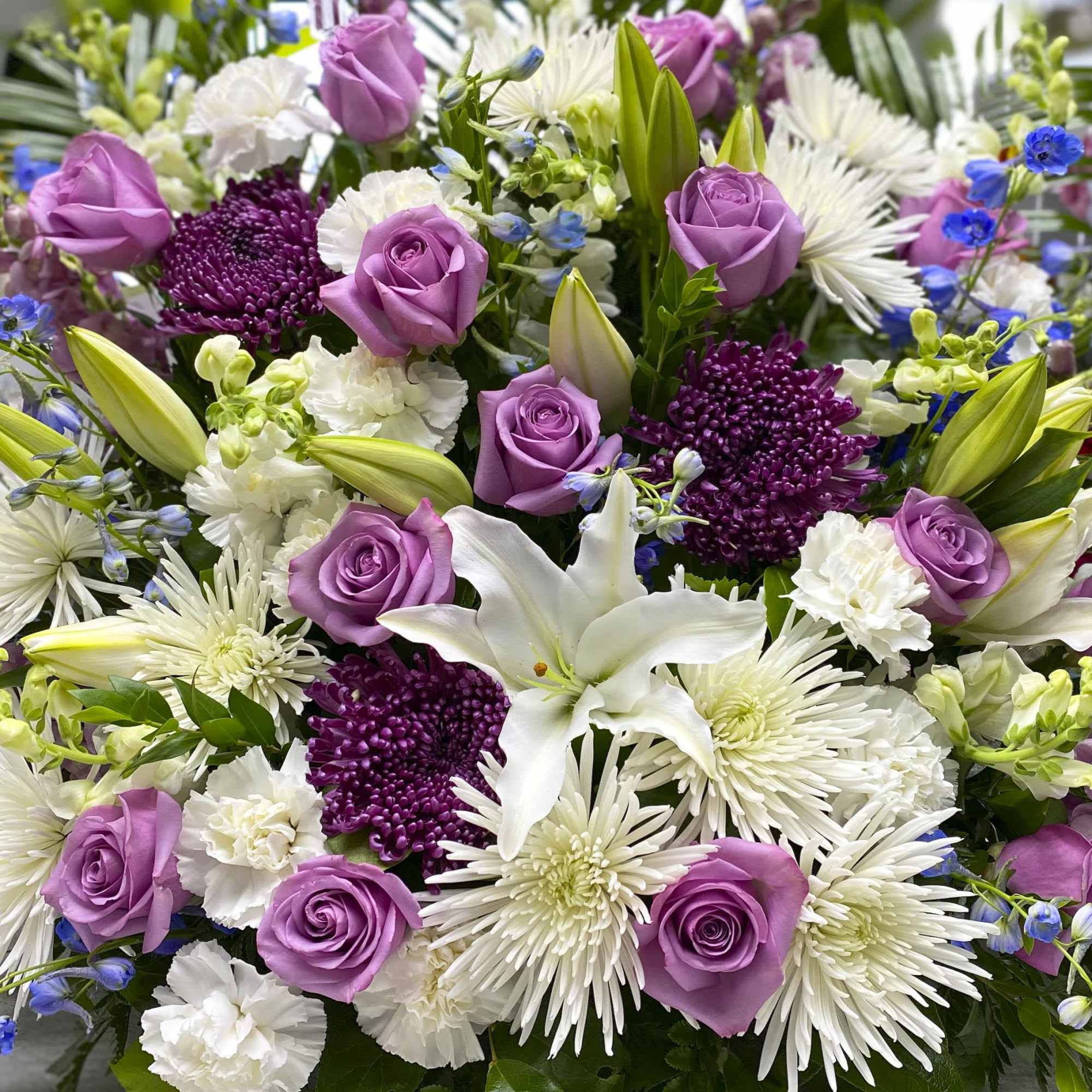 Bouquet of lavender roses, white lilies, and purple chrysanthemums