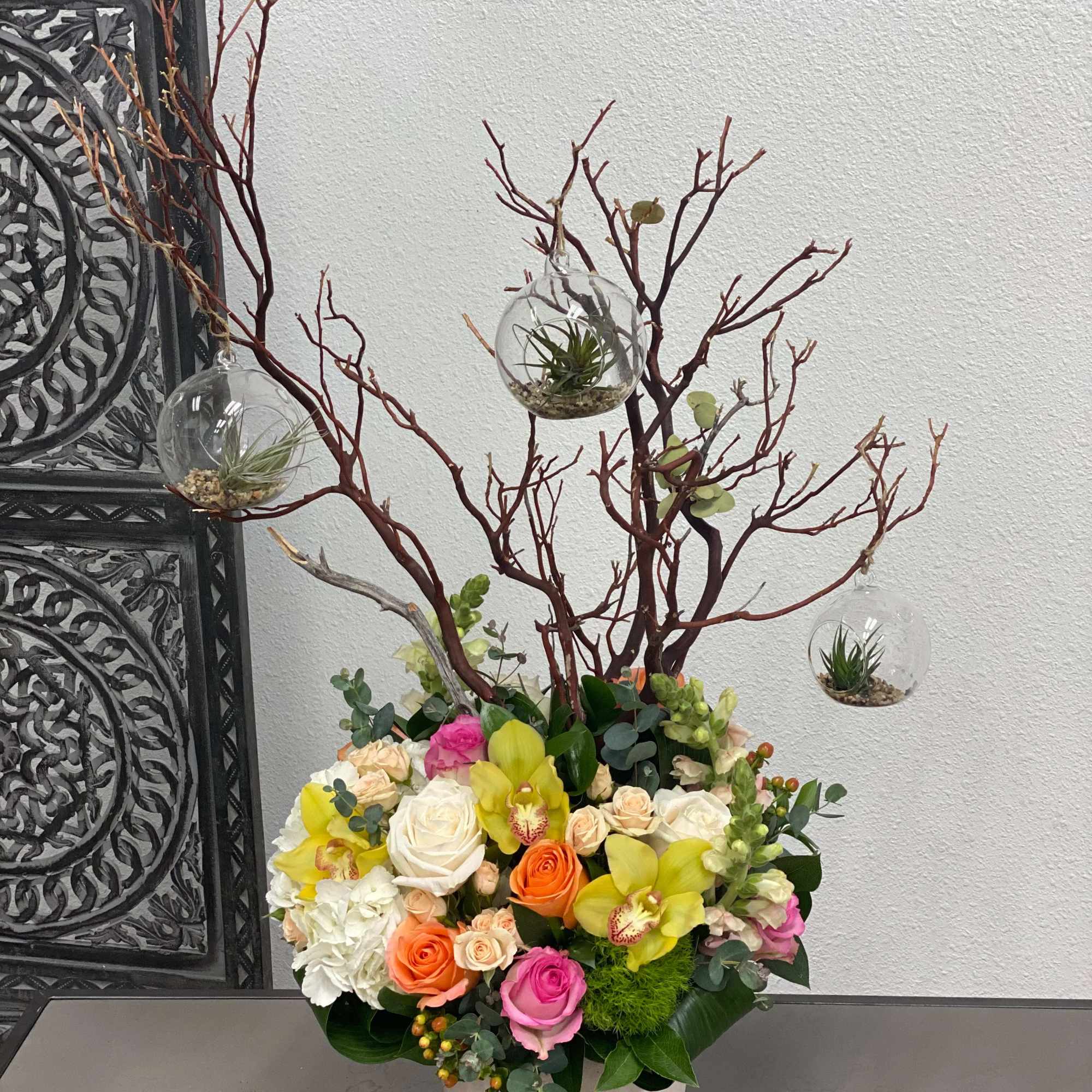 This arrangement includes a vibrant variety of flowers and a manzanita branch, photo 3 of 3