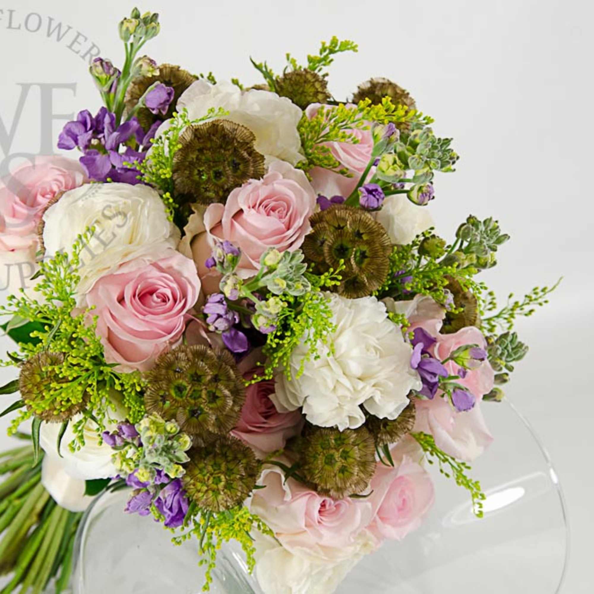 Bouquet of pink and white roses with purple accents