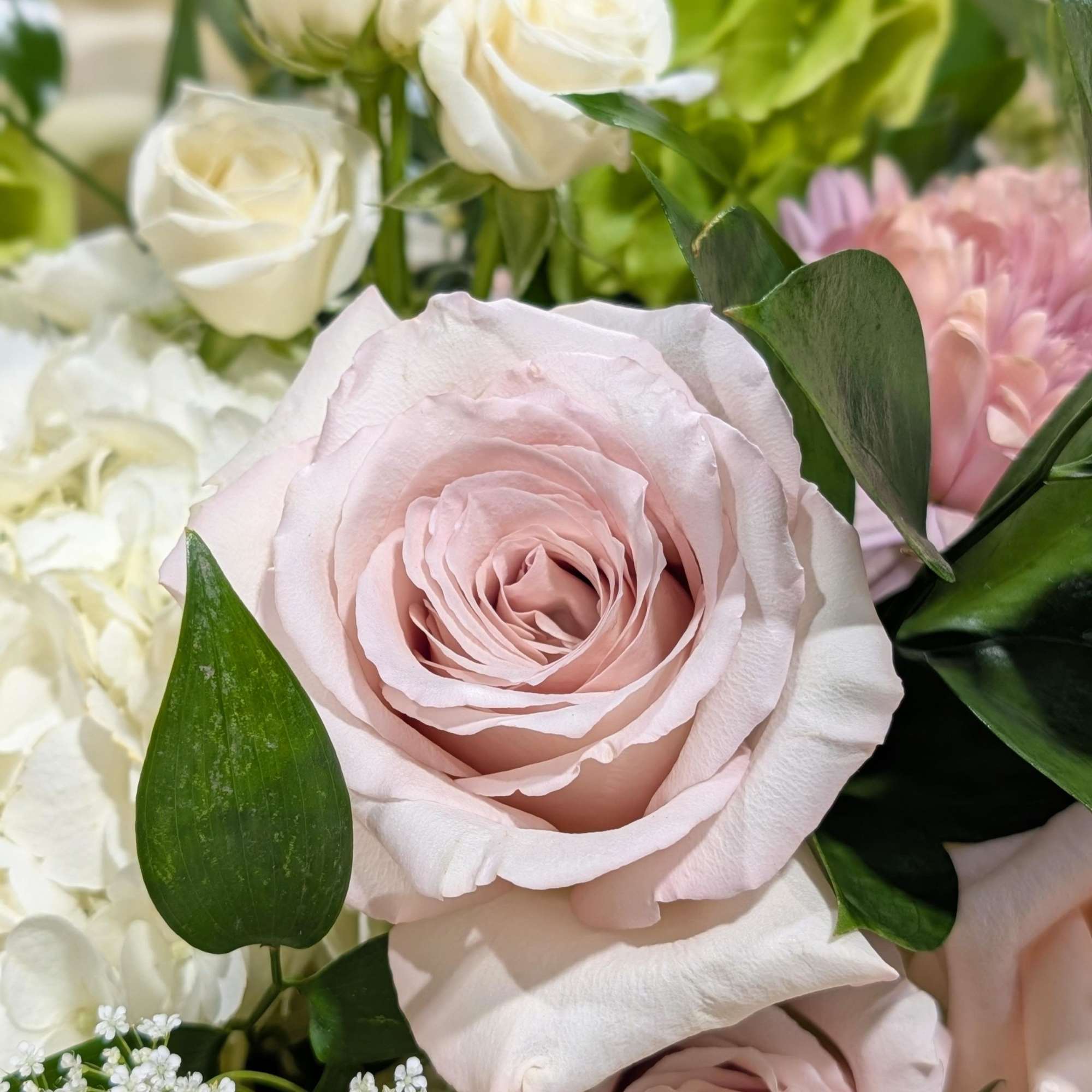 Soft color hues of seasonal flowers design in a mercury glass compote, photo 3 of 3