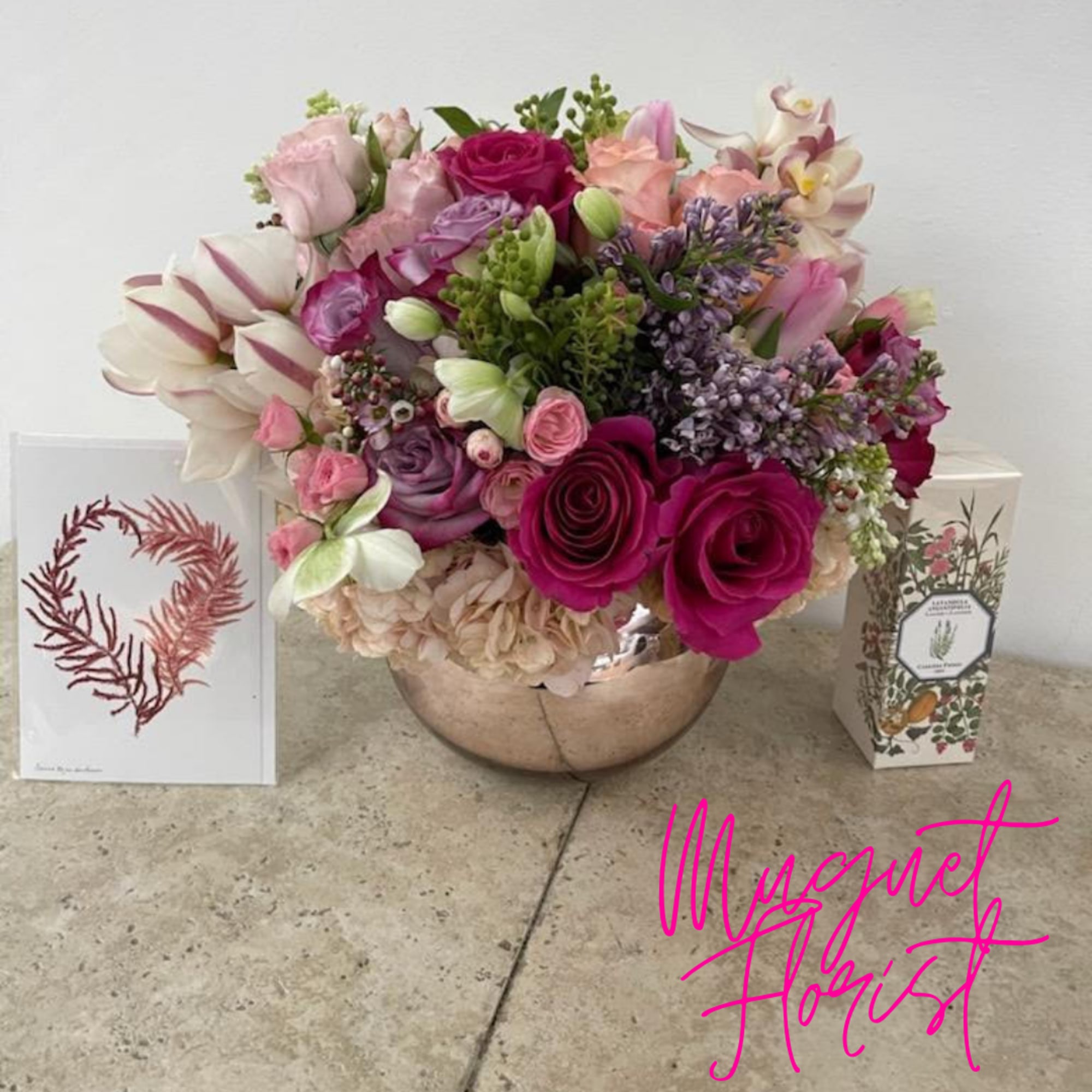 Mixed pink and white flower arrangement in a round metallic vase