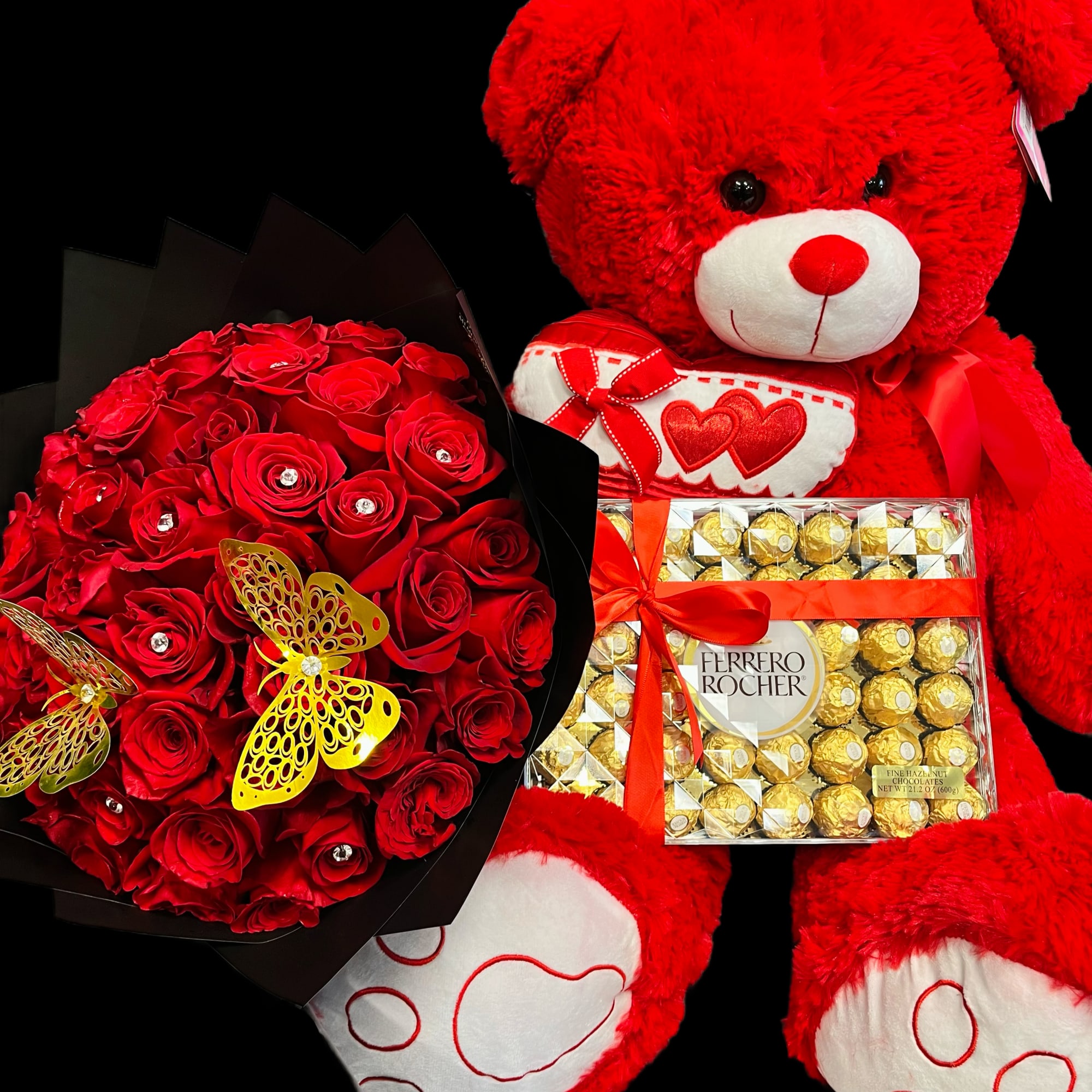 Red rose bouquet with large red teddy bear and Ferrero Rocher chocolates on a black background