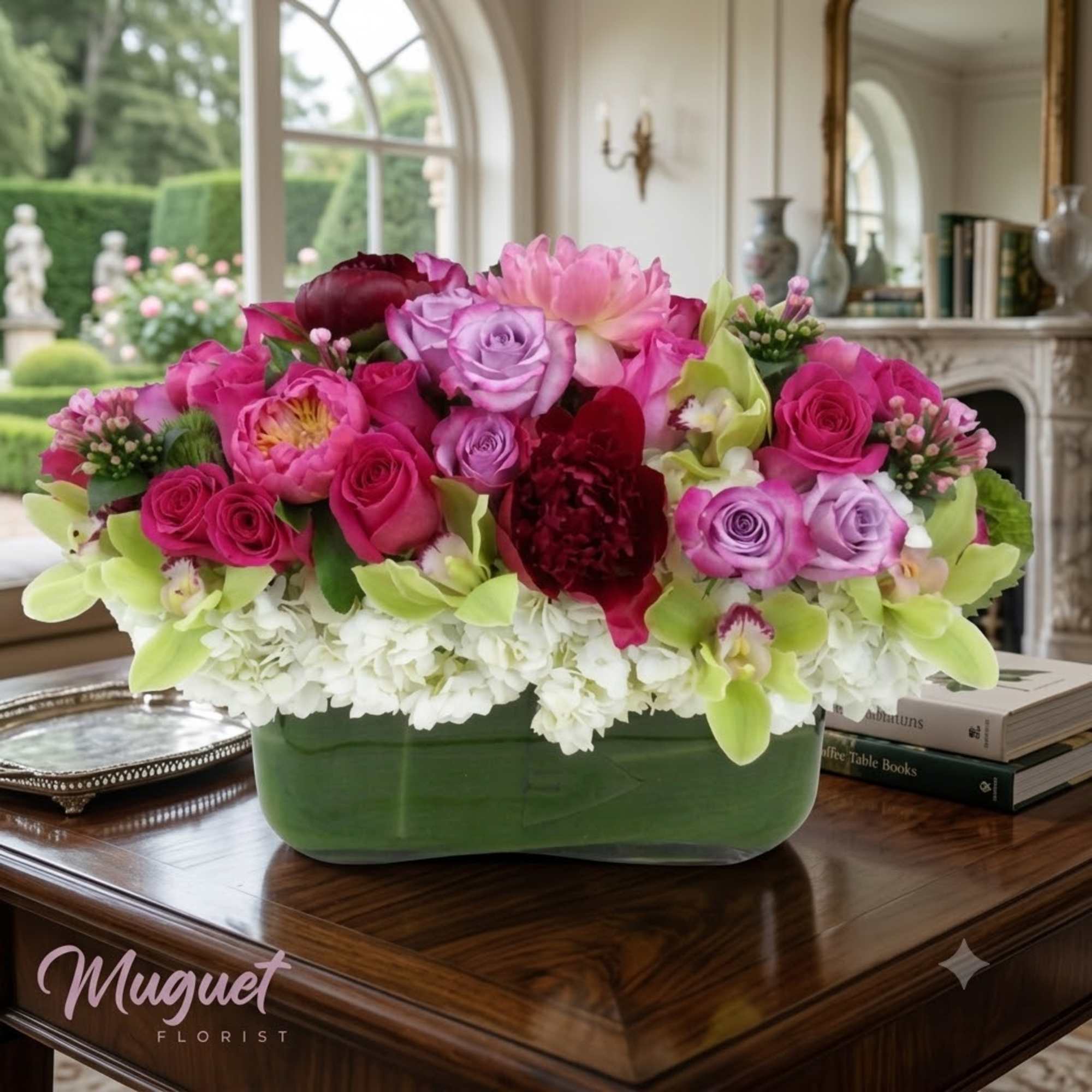 Pink and lavender roses arranged in a green rectangular vase