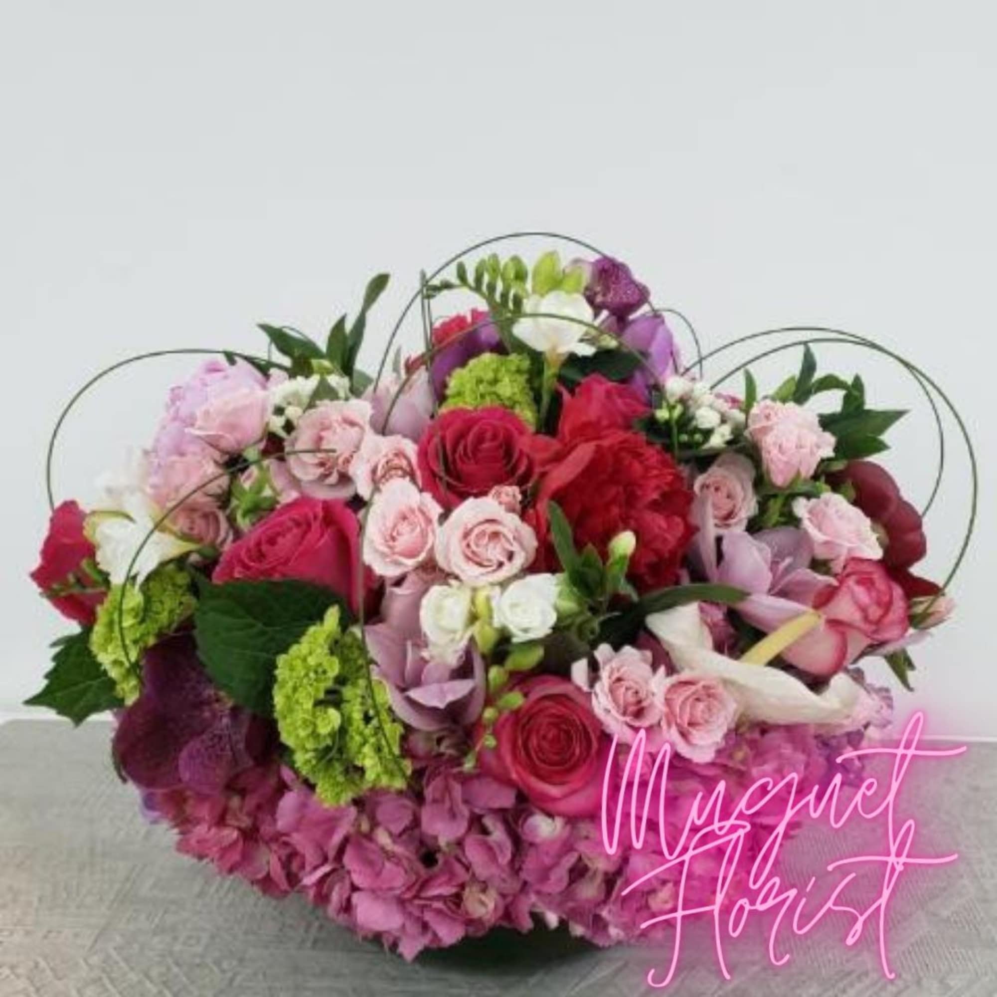 Mixed pink and red floral bouquet with roses and hydrangeas