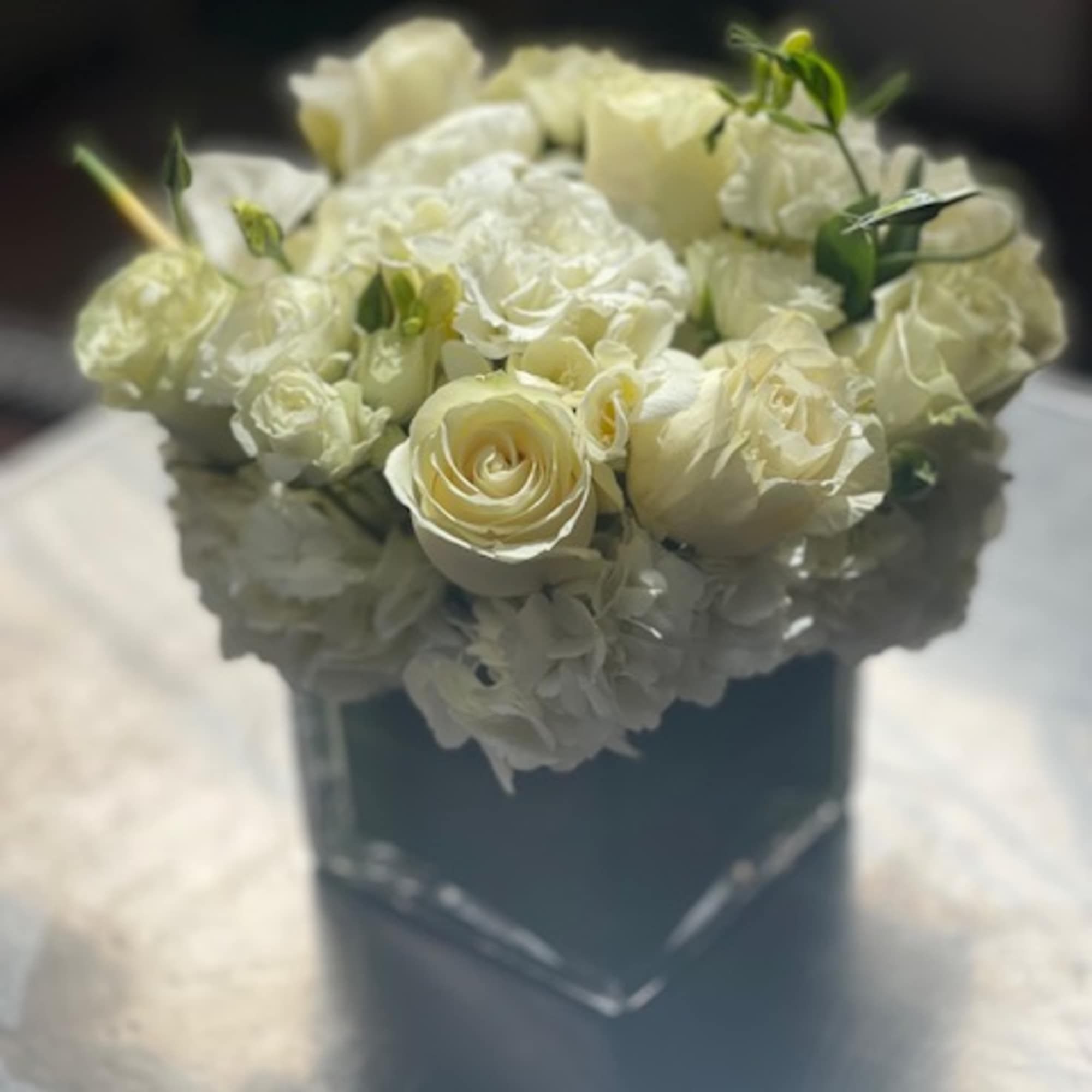 White rose bouquet in a dark box
