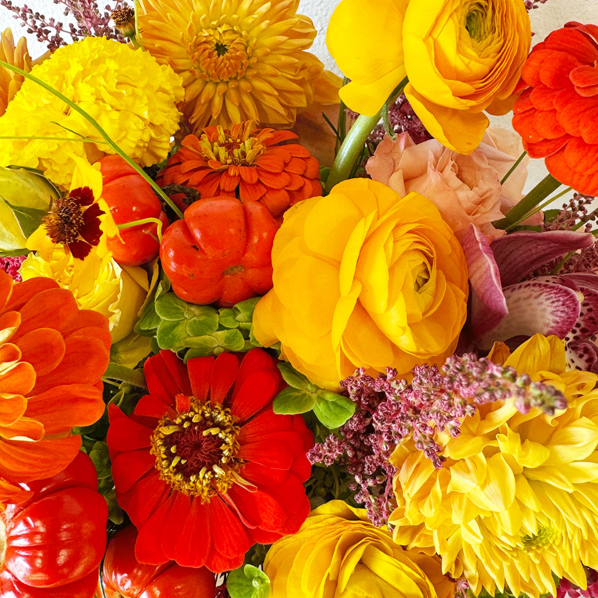 Bright mixed bouquet with yellow, orange, and red flowers