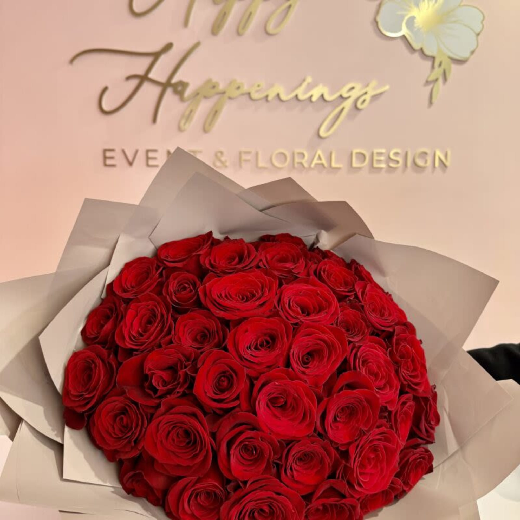 Bouquet of red roses wrapped in pale paper
