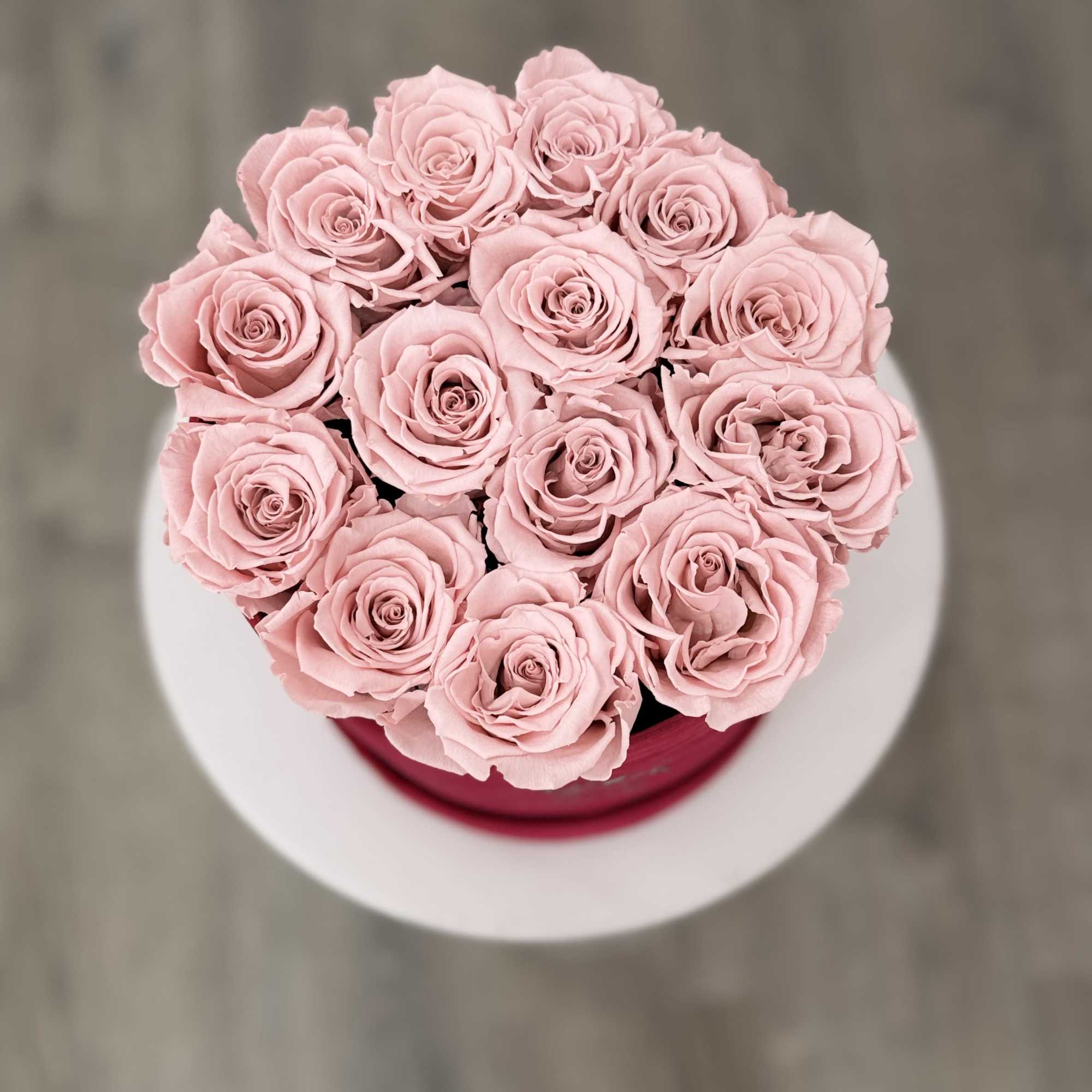 Bouquet of pale pink roses in a round box