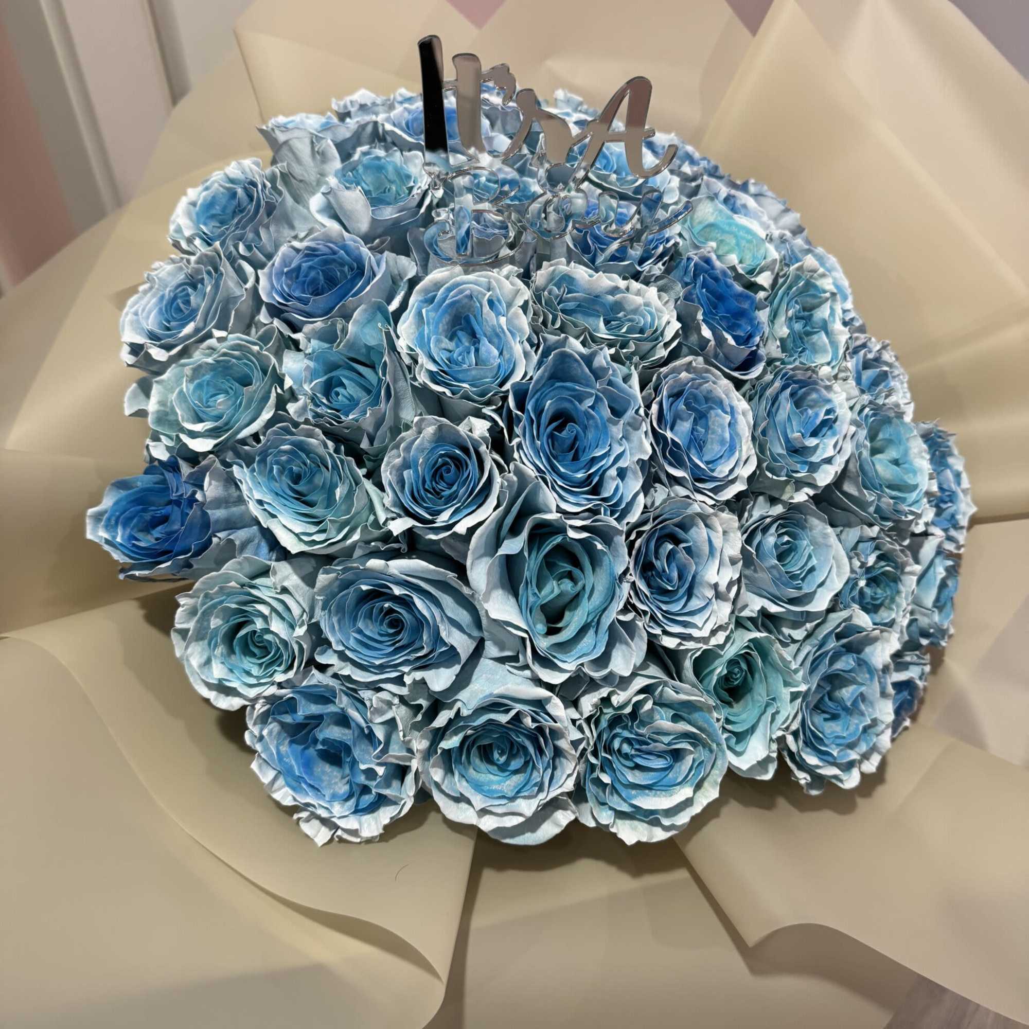 Bouquet of blue roses wrapped in beige paper