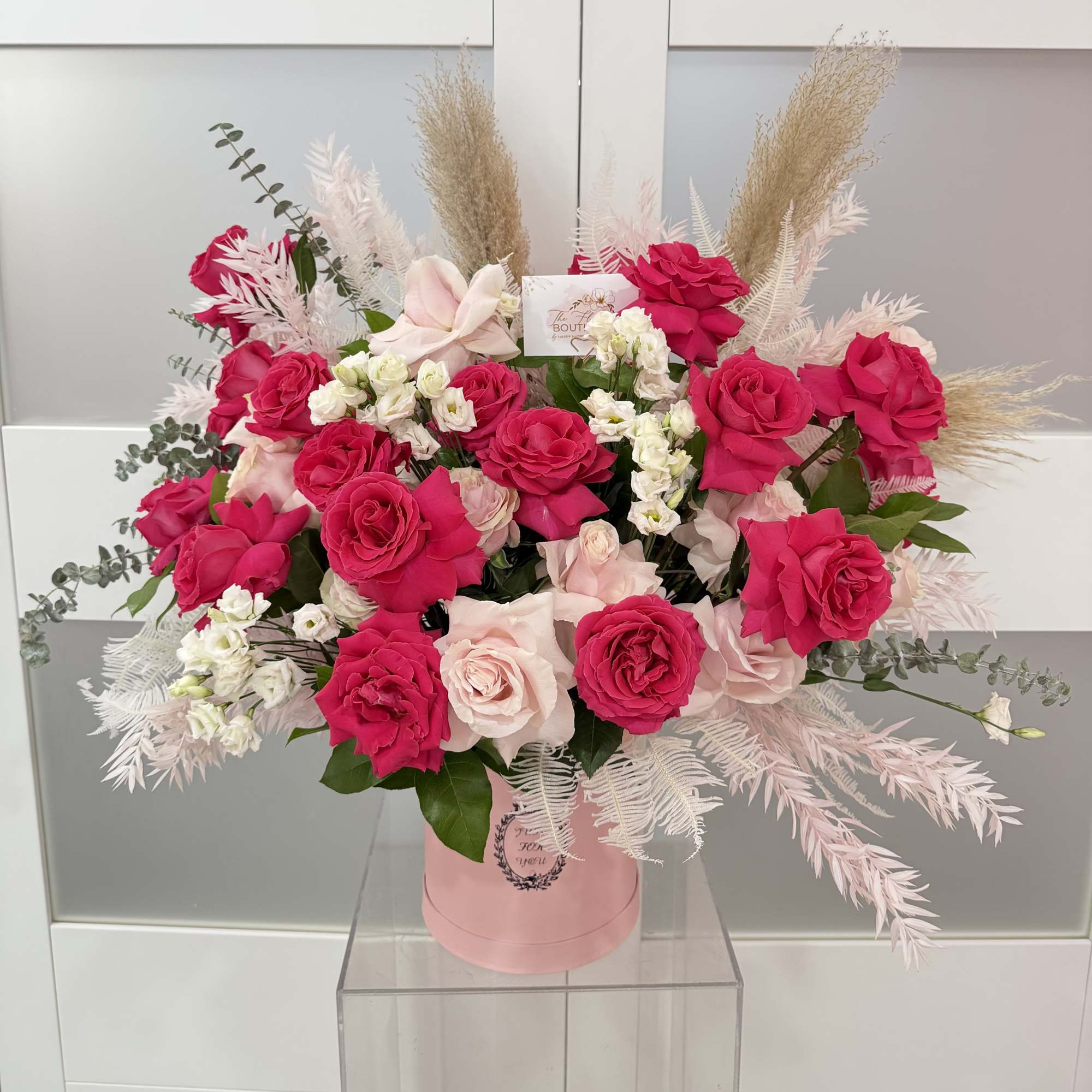 Pink and white rose bouquet in a pink hat box