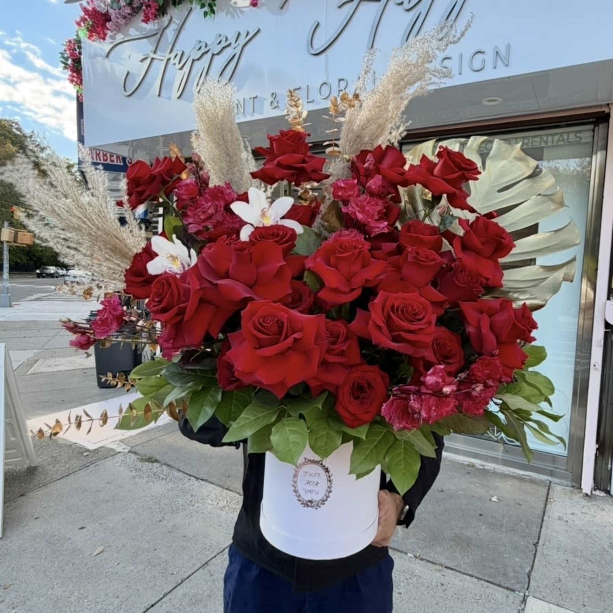 Large red rose arrangement in a white hatbox with pink flowers