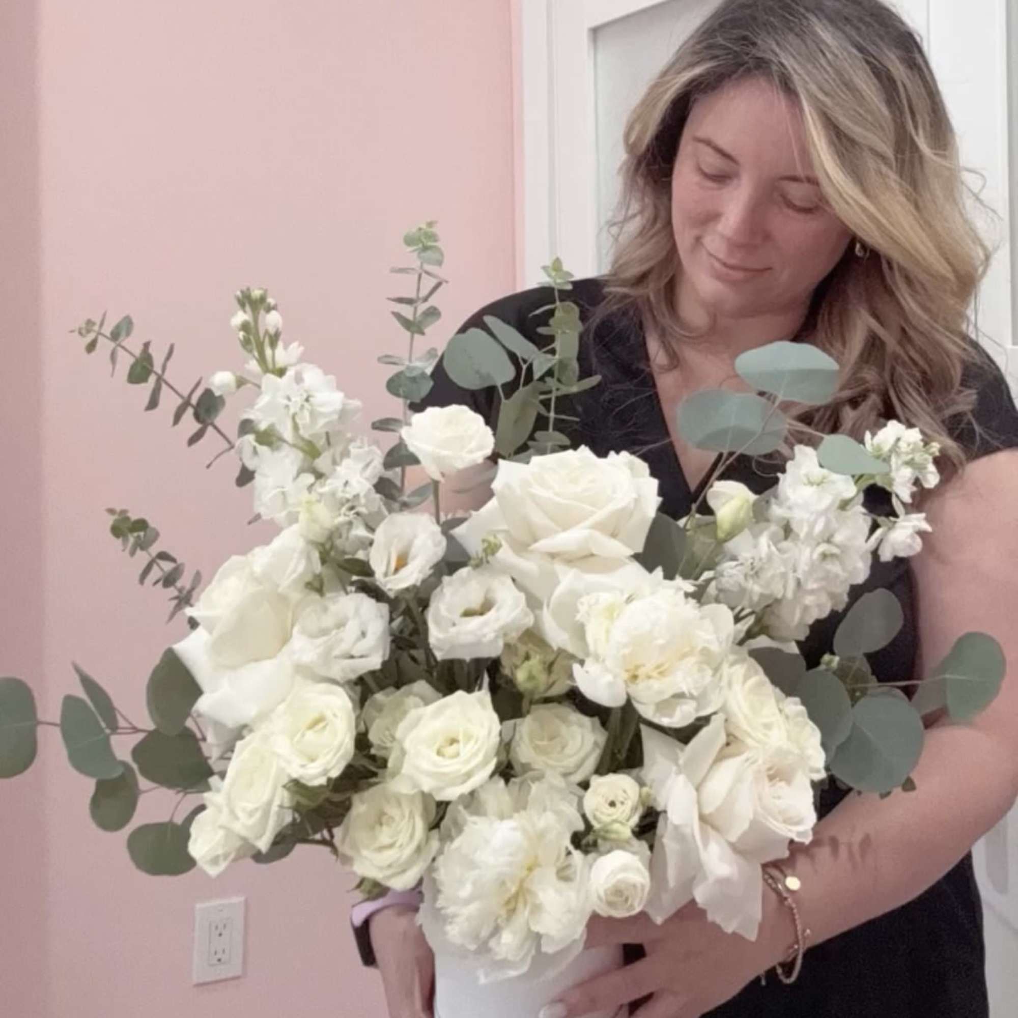 A lush cluster of creamy white roses and delicate lisianthus arranged in, photo 2 of 2