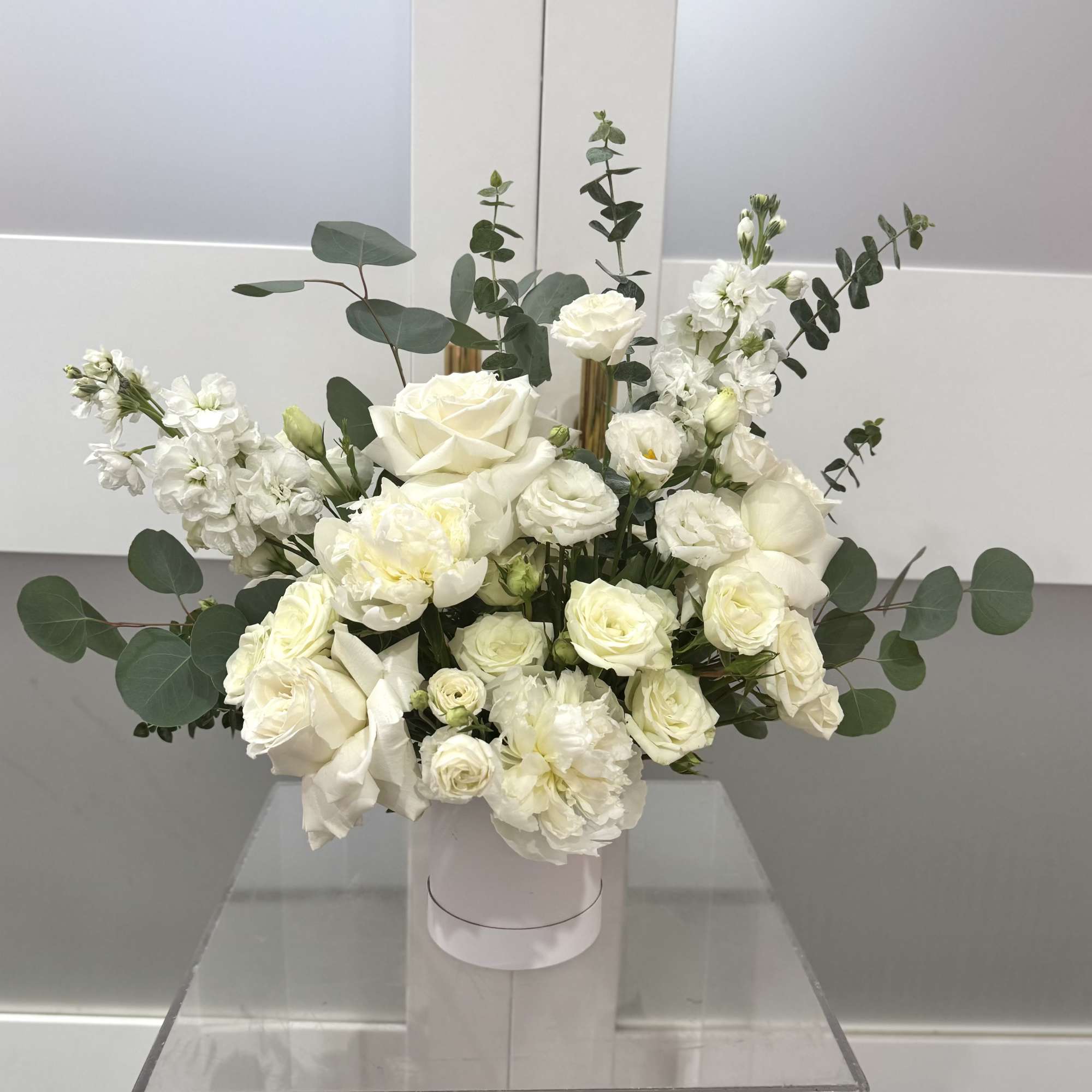 A lush cluster of creamy white roses and delicate lisianthus arranged in
