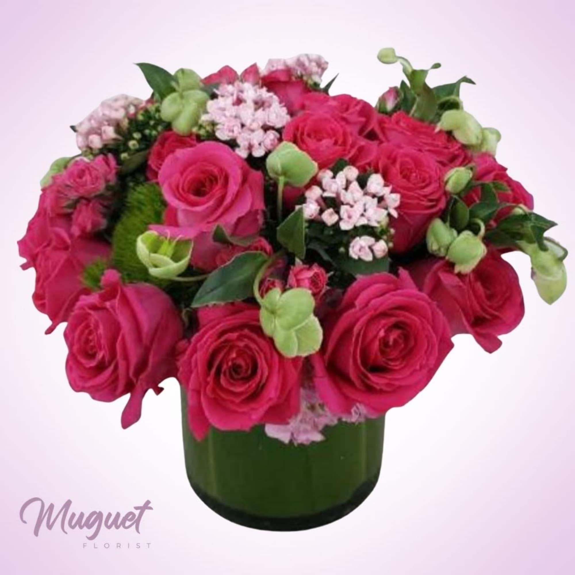 Pink rose bouquet in a green glass vase