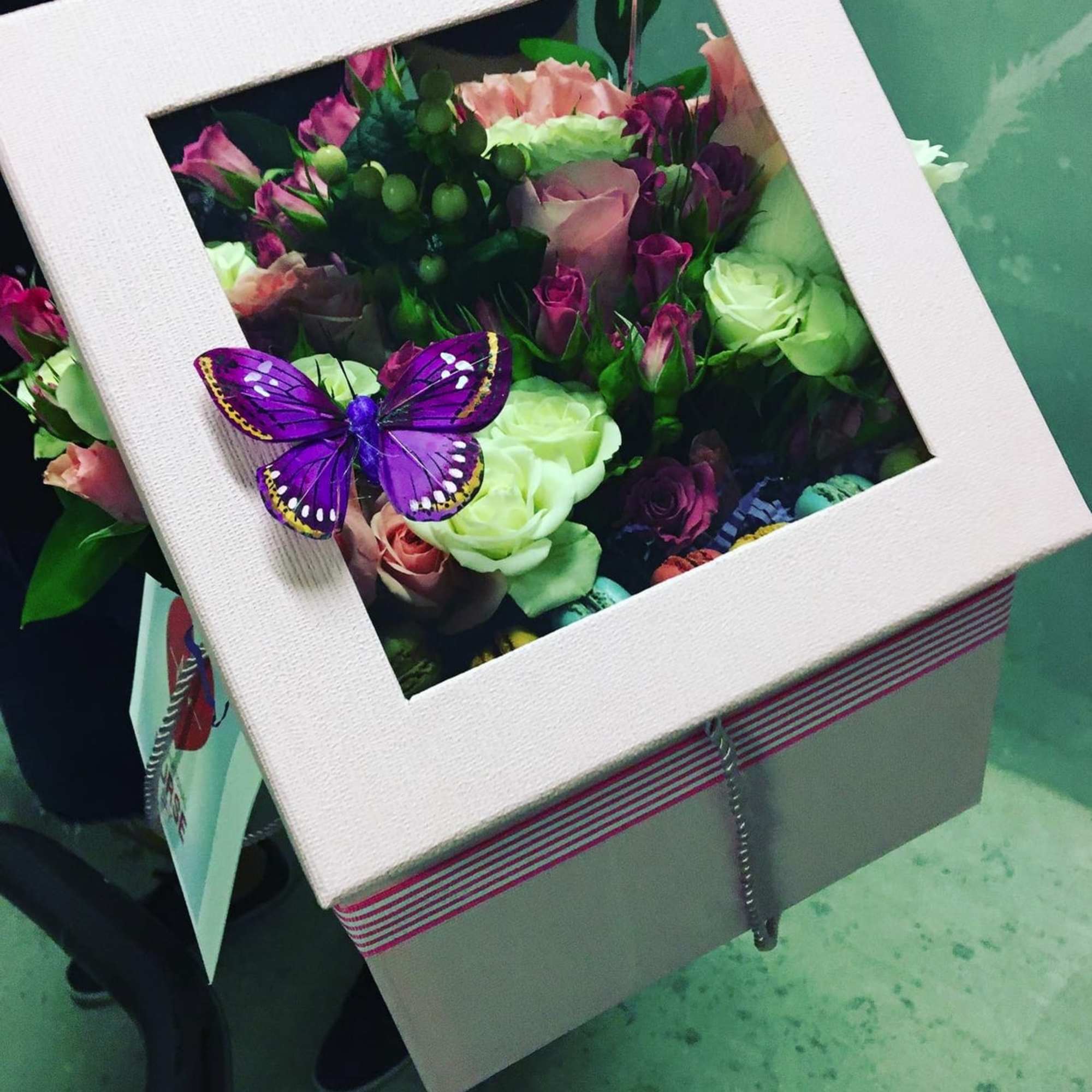 Box of mixed roses with a purple butterfly decoration