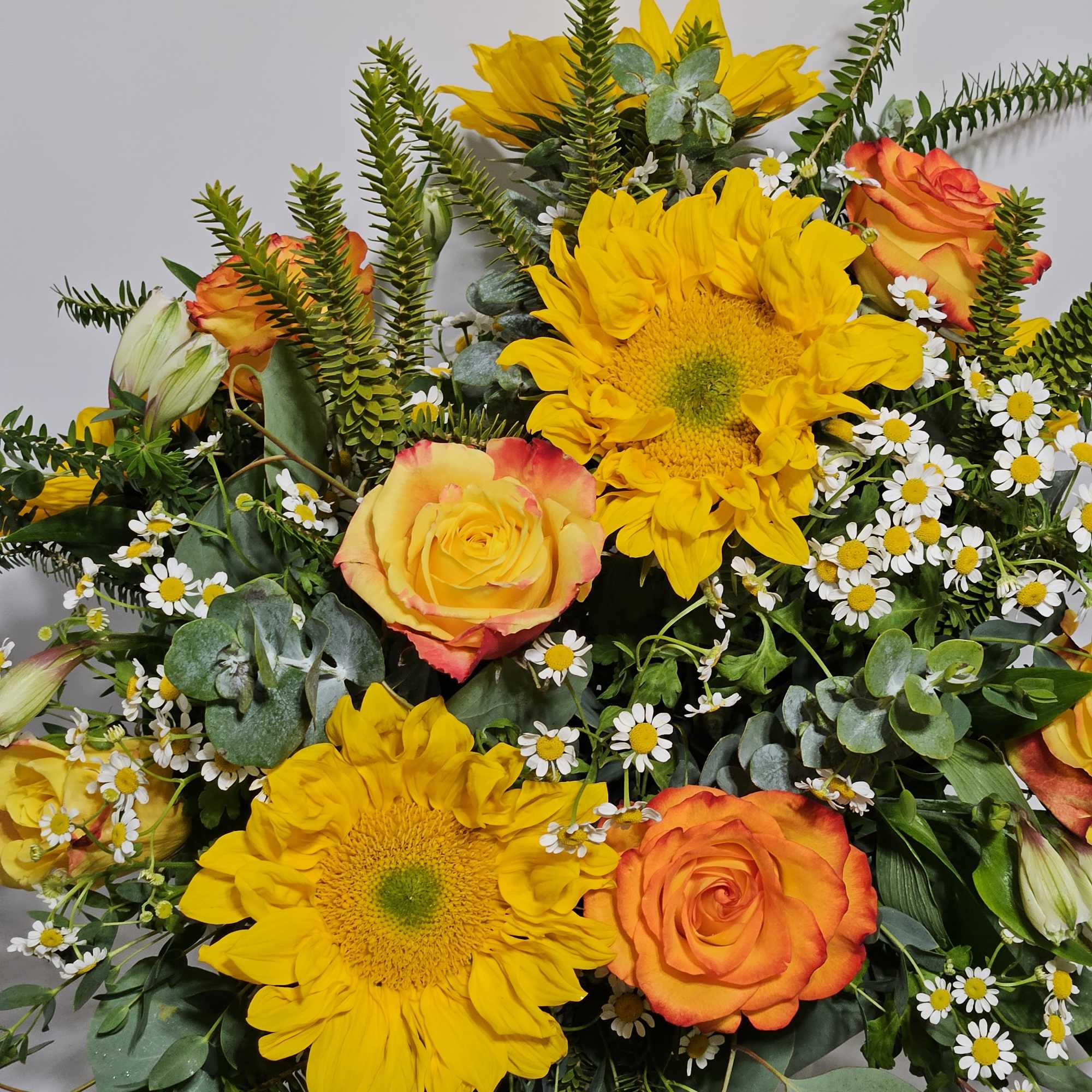 Bouquet of yellow sunflowers, orange roses, and white daisies