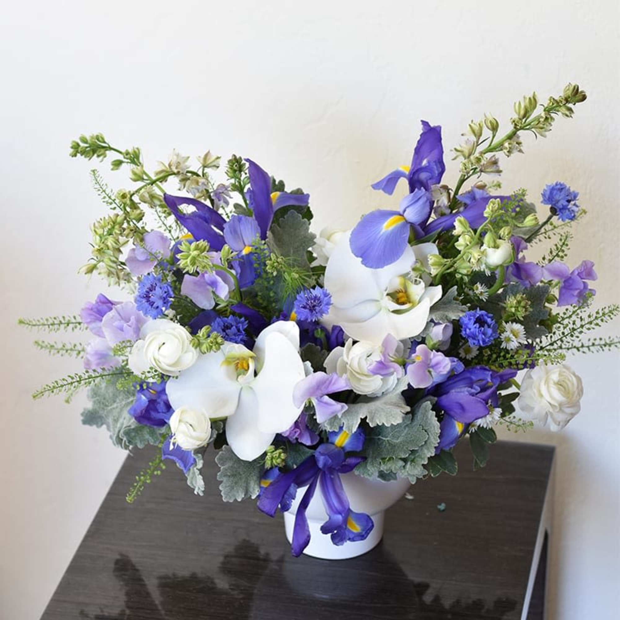 Indulge in the timeless elegance of our exquisite flower arrangement featuring delicate
