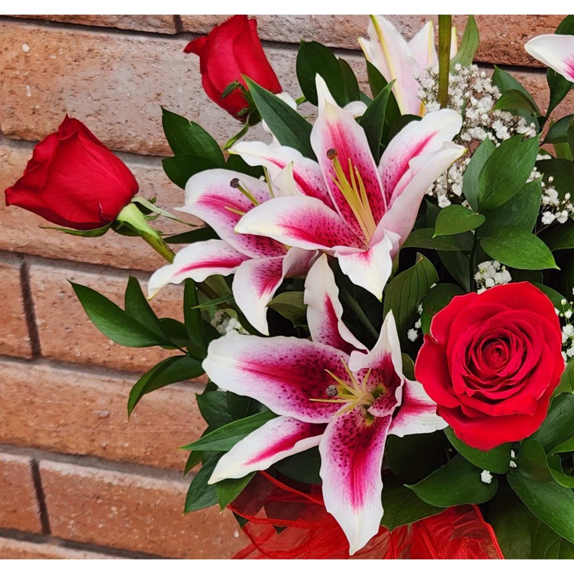 Bouquet of red roses and pink-white lilies