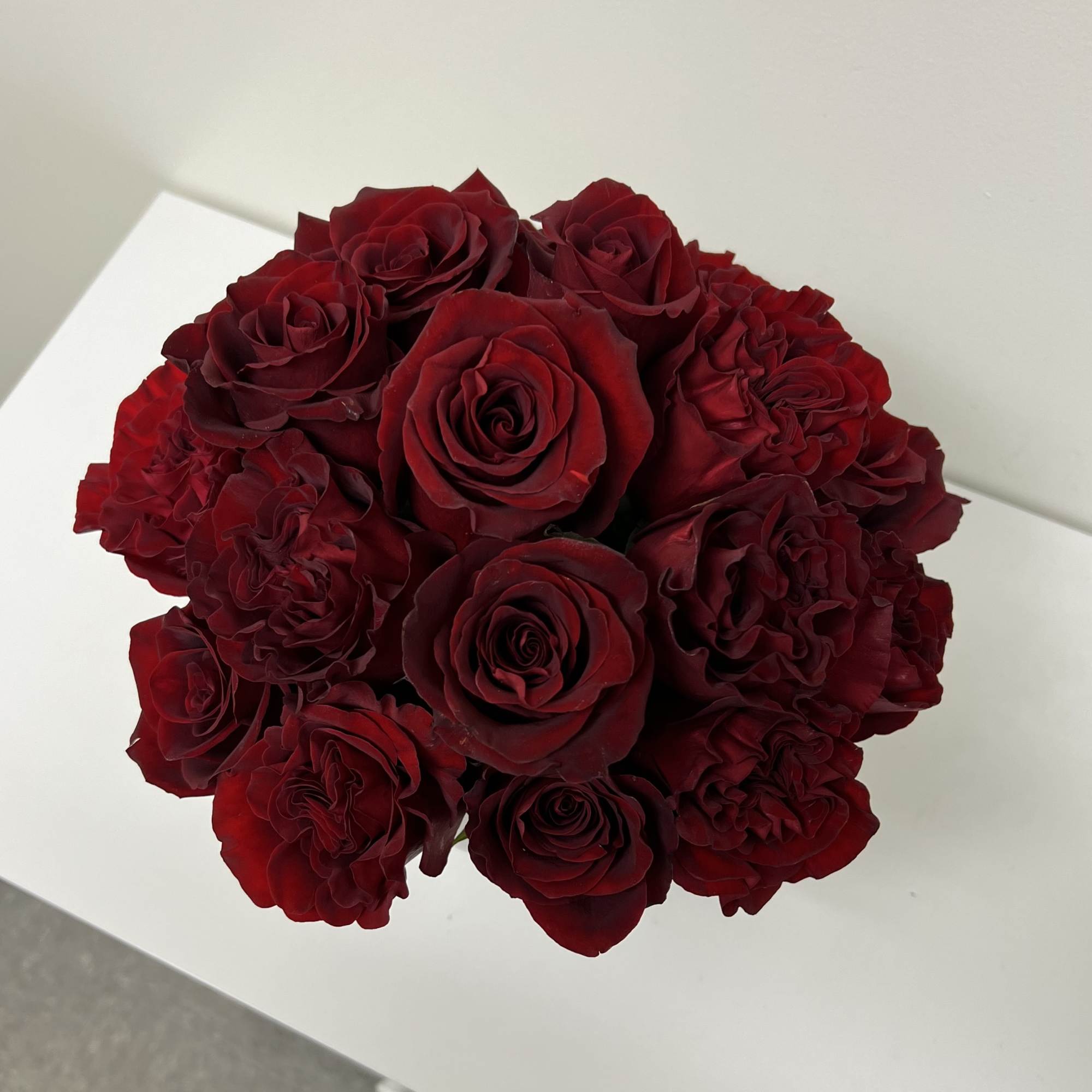 Bouquet of deep red roses arranged in a tight round cluster
