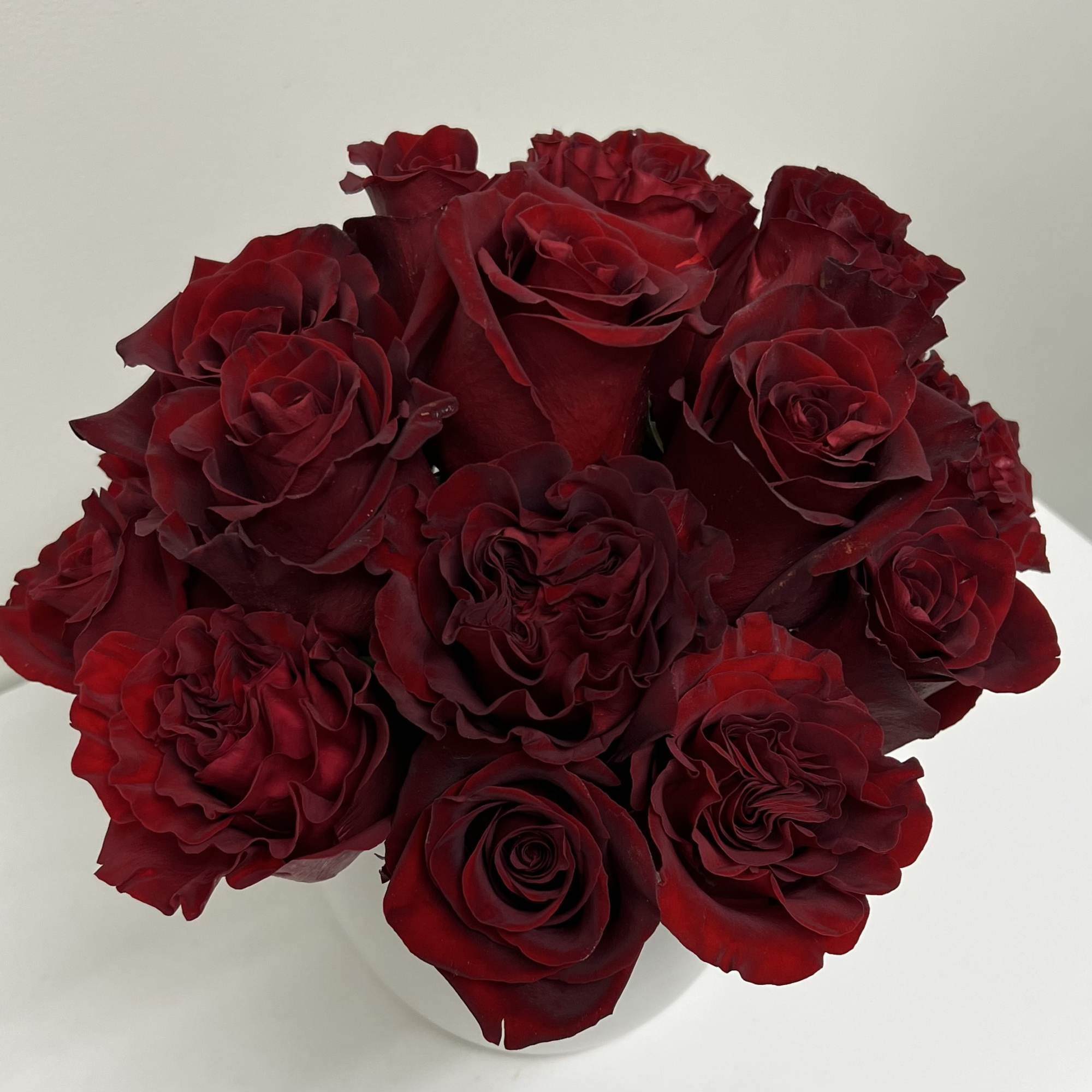 Bouquet of deep red roses in a white vase, photo 3 of 4