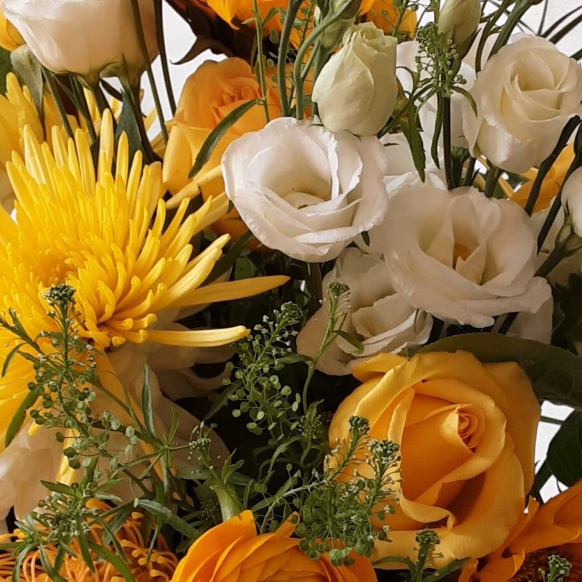Bouquet of yellow and white flowers with orange roses