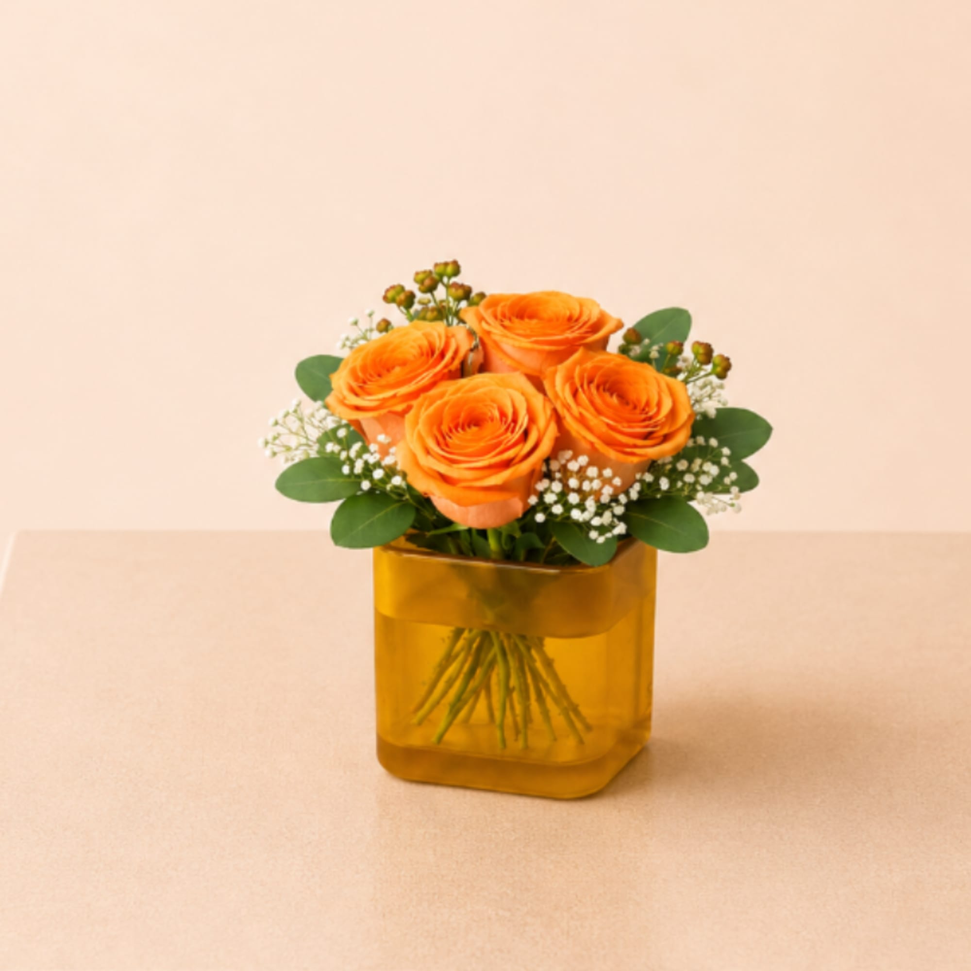 A charming flower arrangement featuring four premium roses, accented with delicate filler