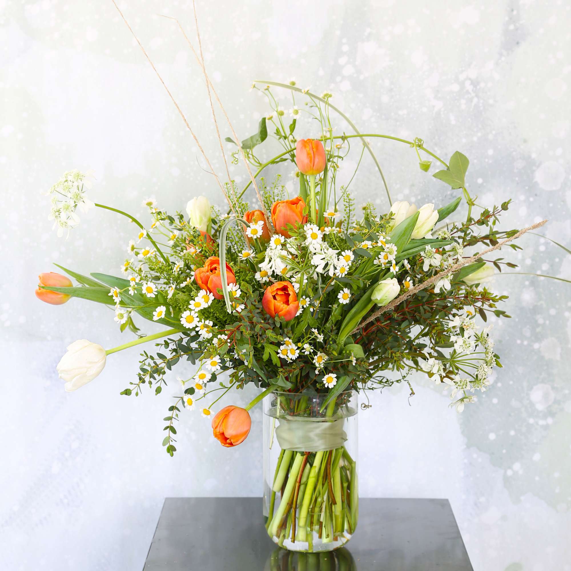 An adorable wild flower style bouquet create by Orange and Ivory tulip