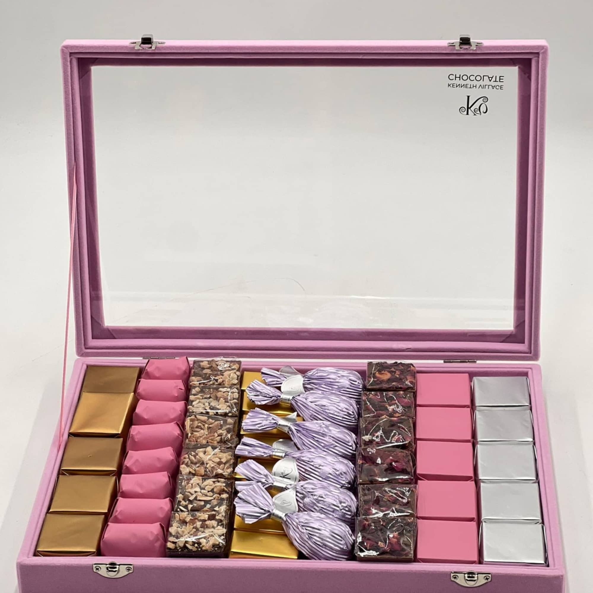 Pink gift box with assorted wrapped chocolates and candies
