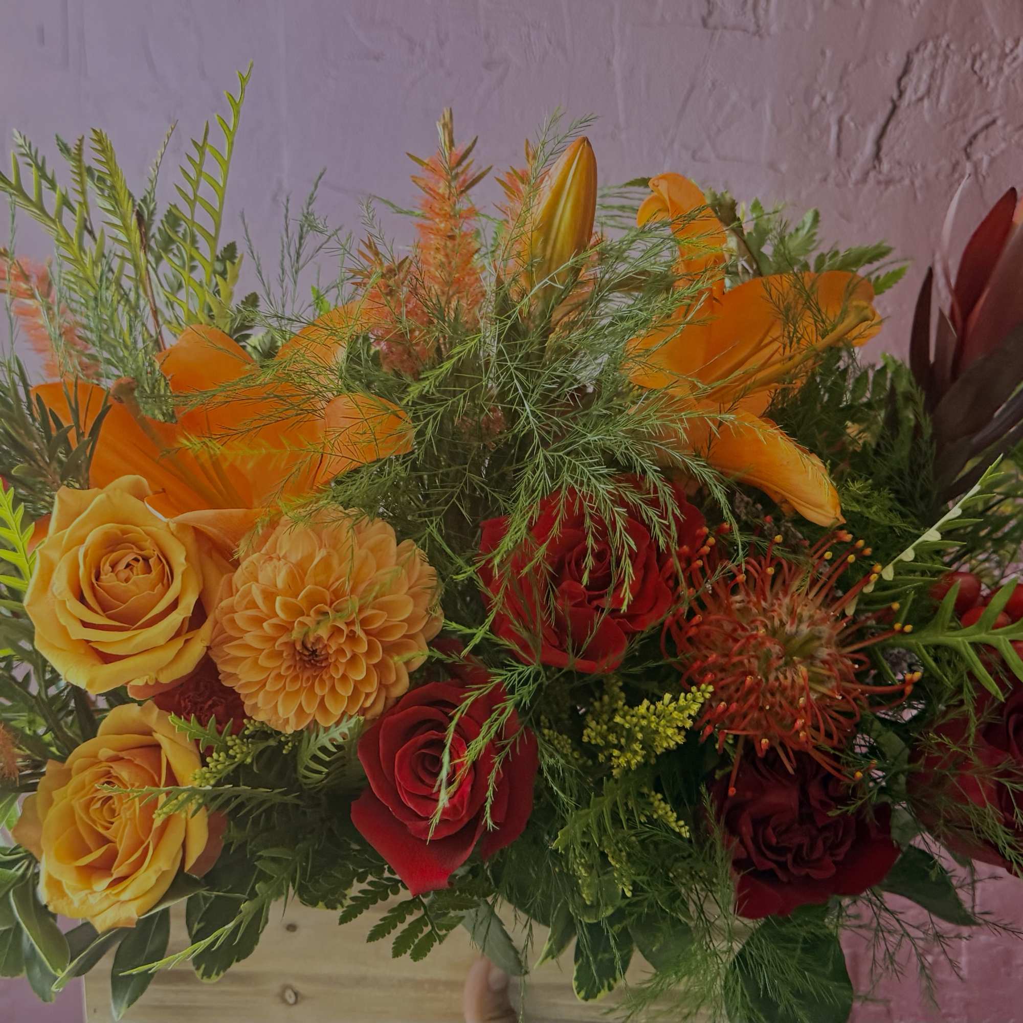 Bright mixed bouquet with orange, yellow, and red flowers