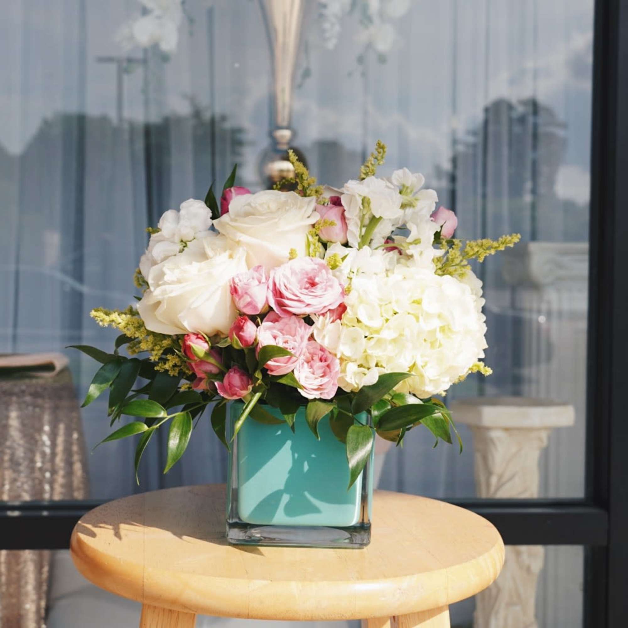 A soft cluster of blush-pink roses and creamy white hydrangea-like blooms framed, photo 3 of 3
