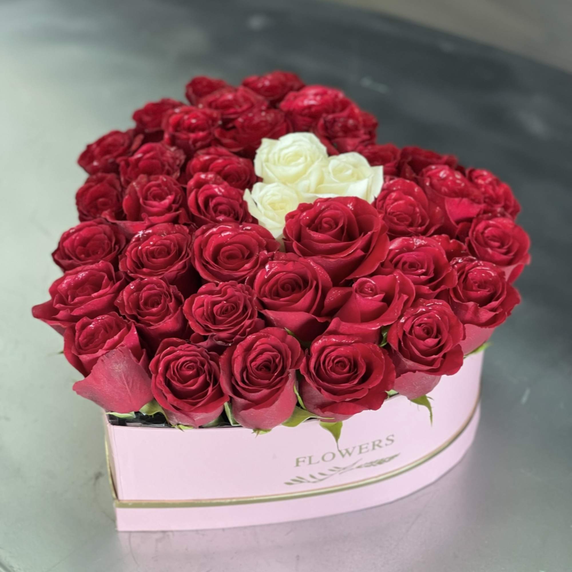 Heart-shaped box of red and white roses
