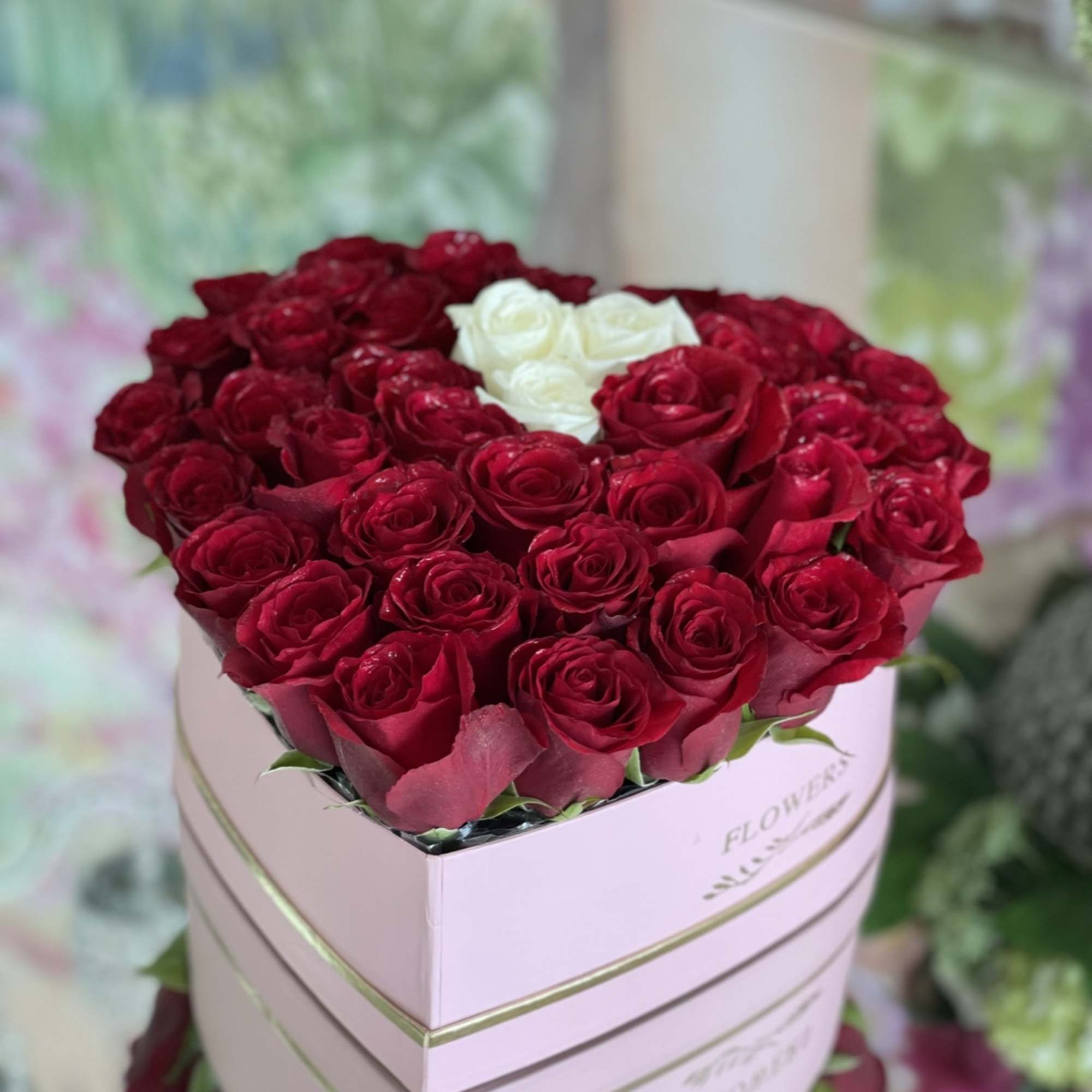 Heart-shaped box of red and white roses