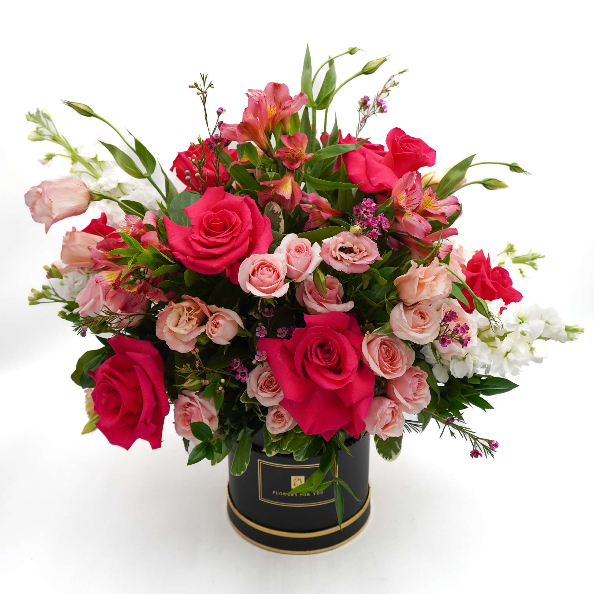 Bouquet of pink and red roses in a black round box