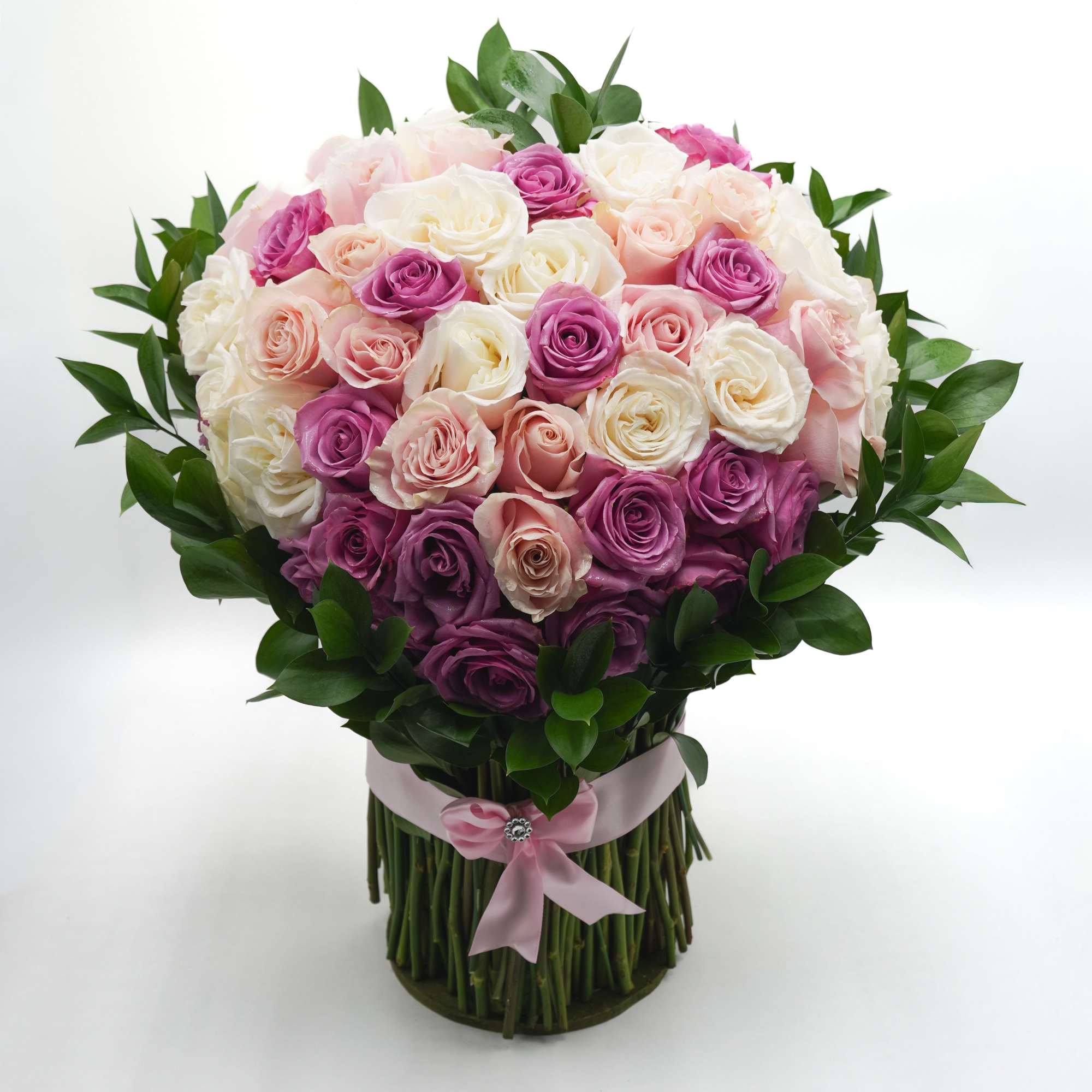 A romantic mix of pink, lavender, and white roses arranged in a